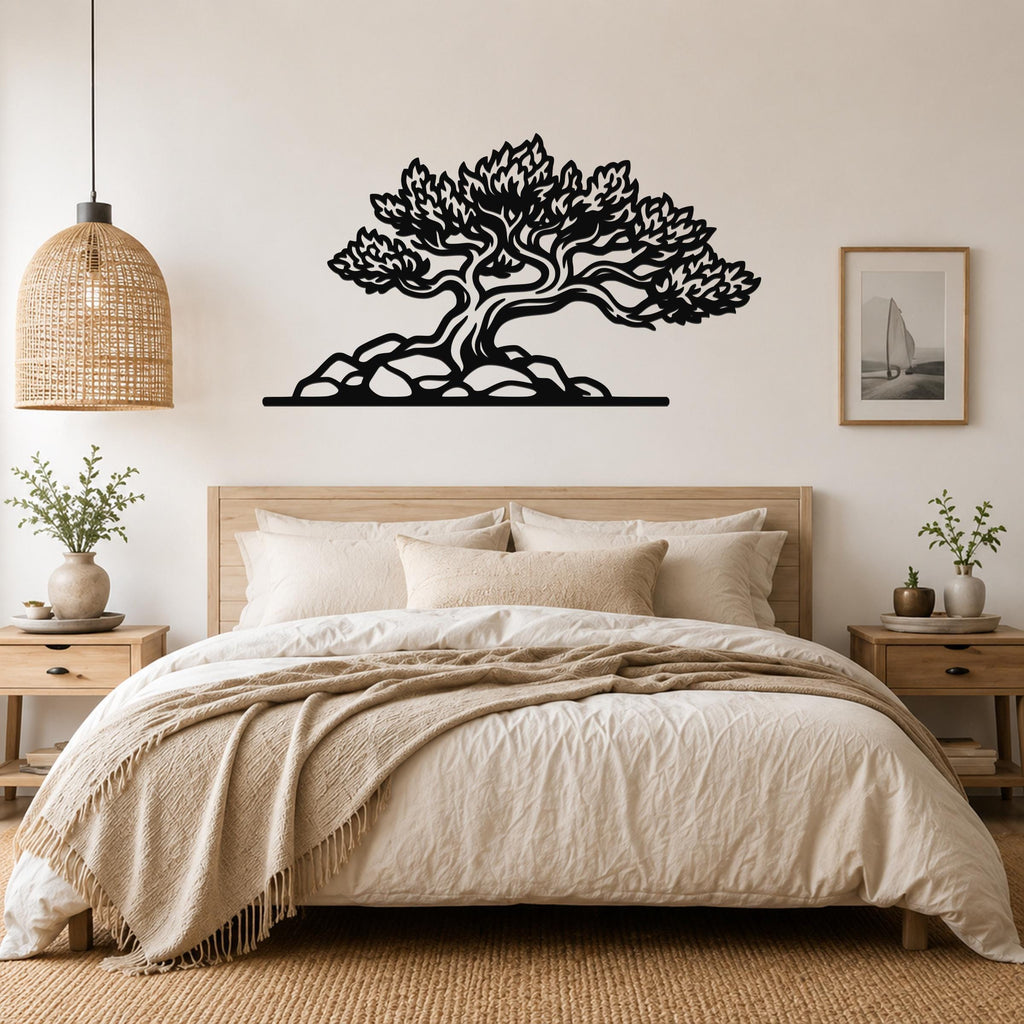 Black metal wall art of a juniper tree with intricate branch and leaf cutouts, mounted above a bed in a neutral bedroom.