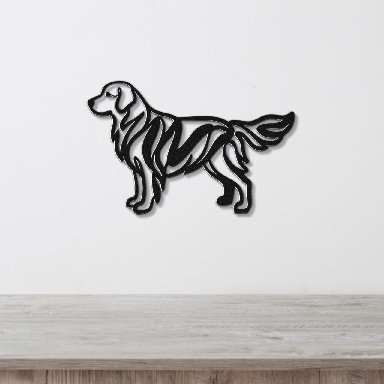Black metal wall art of a golden retriever in a modern cutout style with internal line details, mounted on a white wall above a light wood surface.