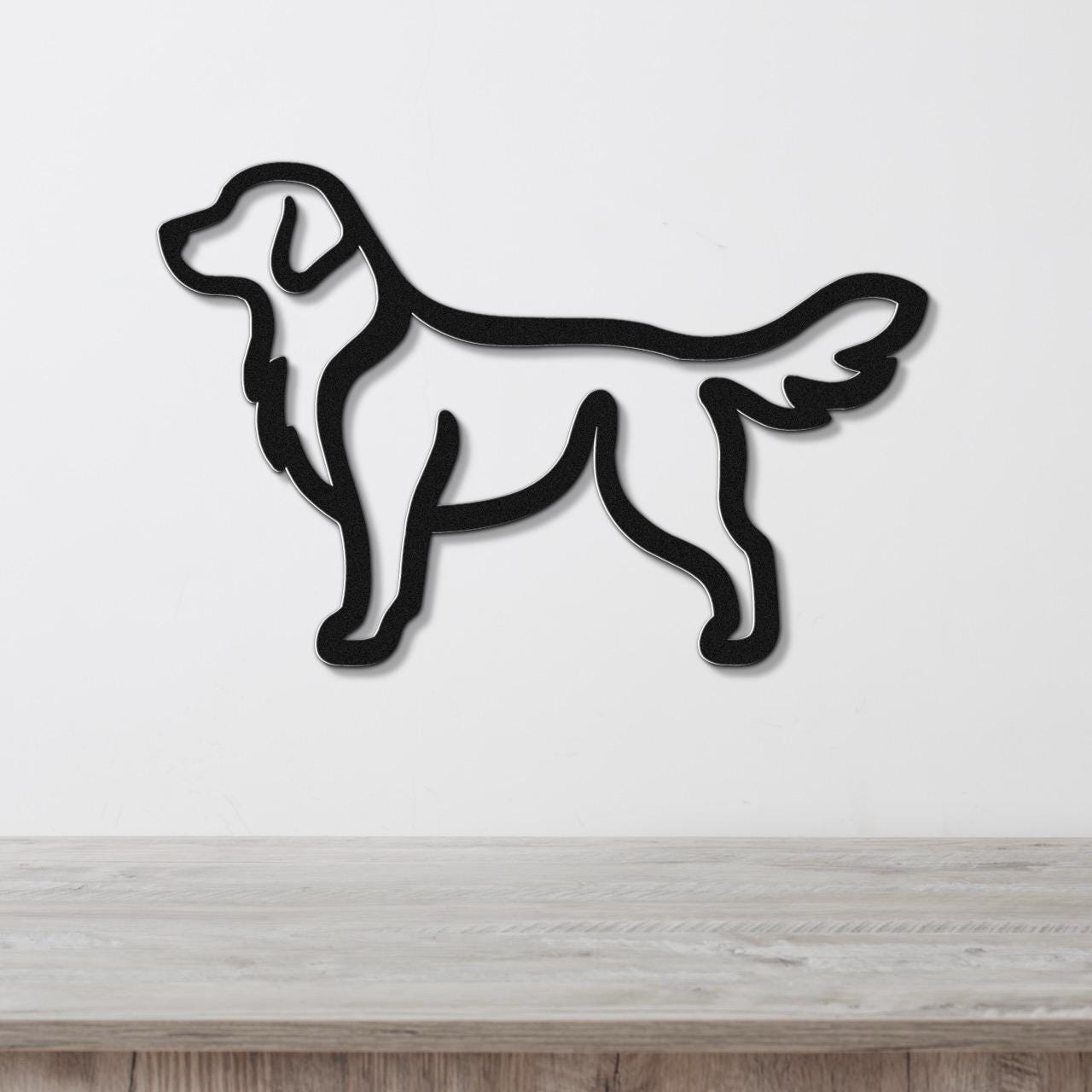 Black metal retriever silhouette wall art with a clean outline, mounted on a white wall above a light wood surface.