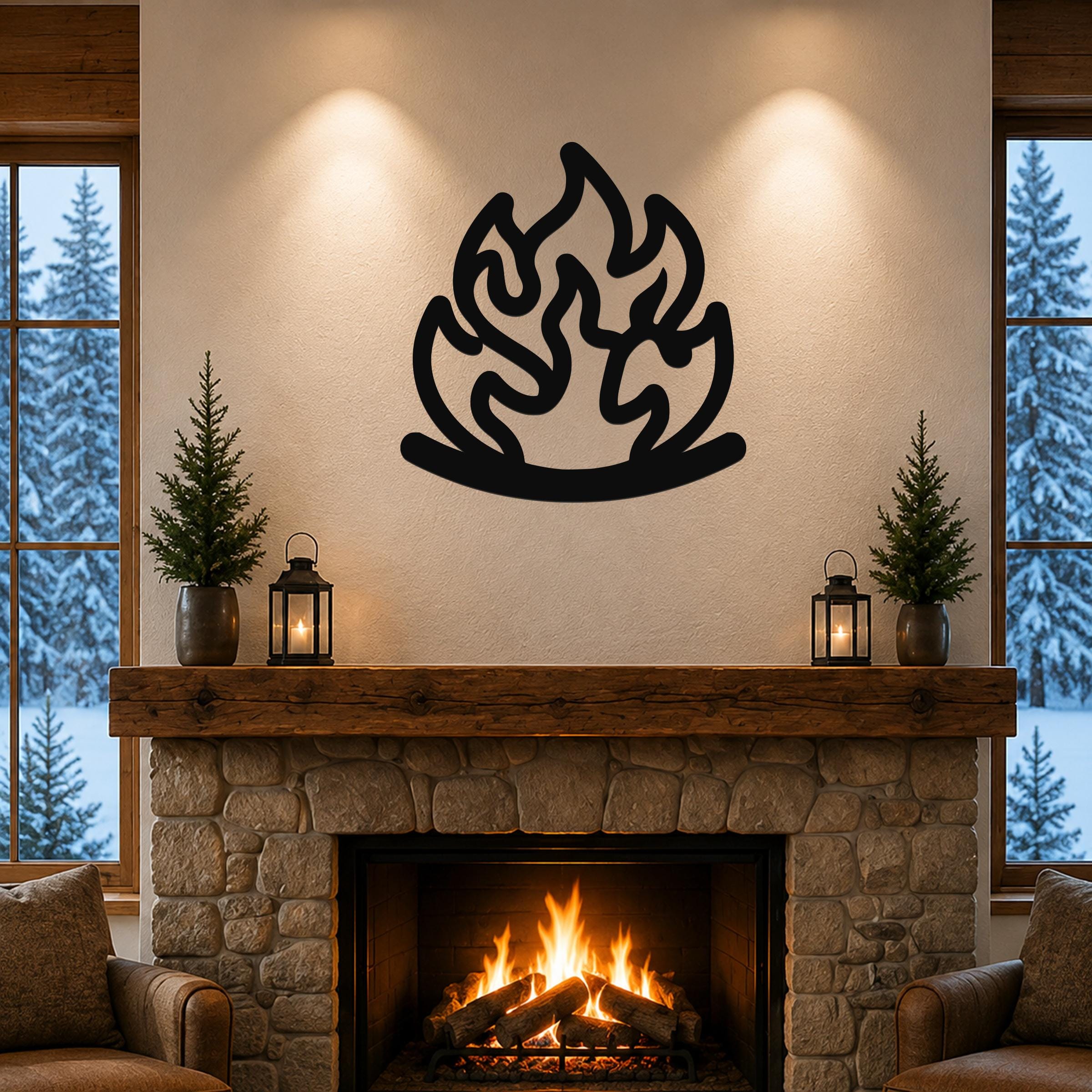 Black metal flame wall art with fluid motion cutouts, mounted above a stone fireplace in a cozy living room with snow outside.