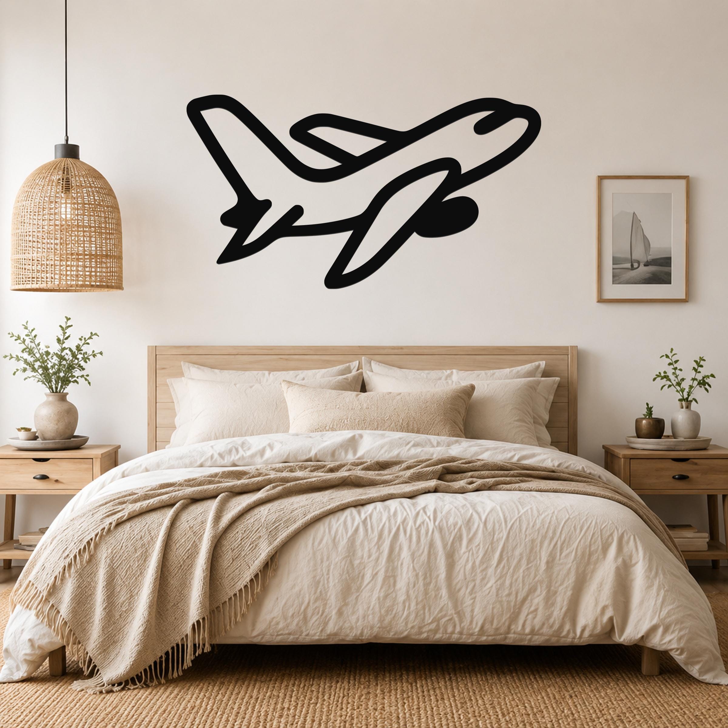 Black metal airplane wall art with a sleek silhouette design, mounted above a wooden bed in a neutral-toned bedroom.