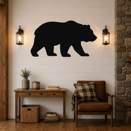 Black metal bear silhouette wall art mounted on a white shiplap wall above a wooden console table in a rustic living room.