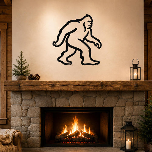 Black metal Bigfoot silhouette wall art mounted above a stone fireplace in a rustic living room.