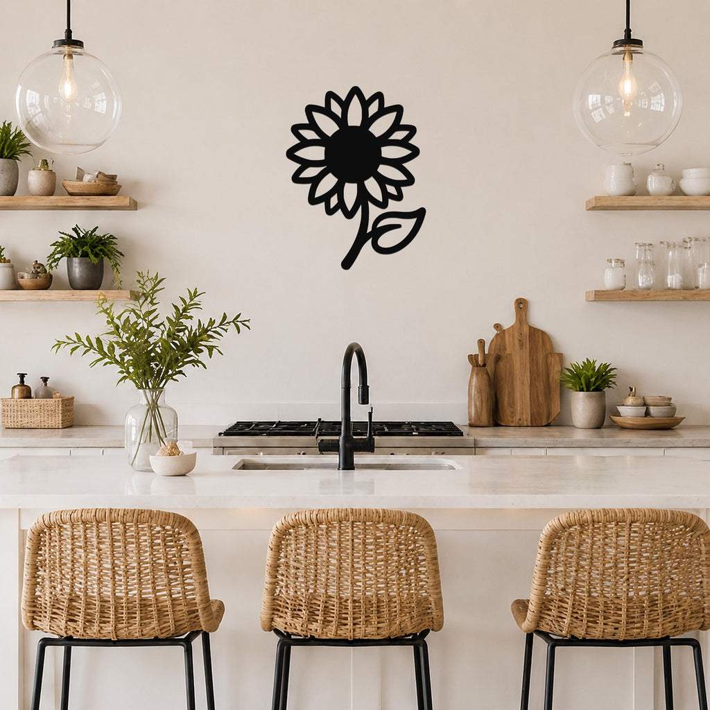 Black metal sunflower wall art with a bold silhouette and leaf detail, mounted on a kitchen wall above a counter.