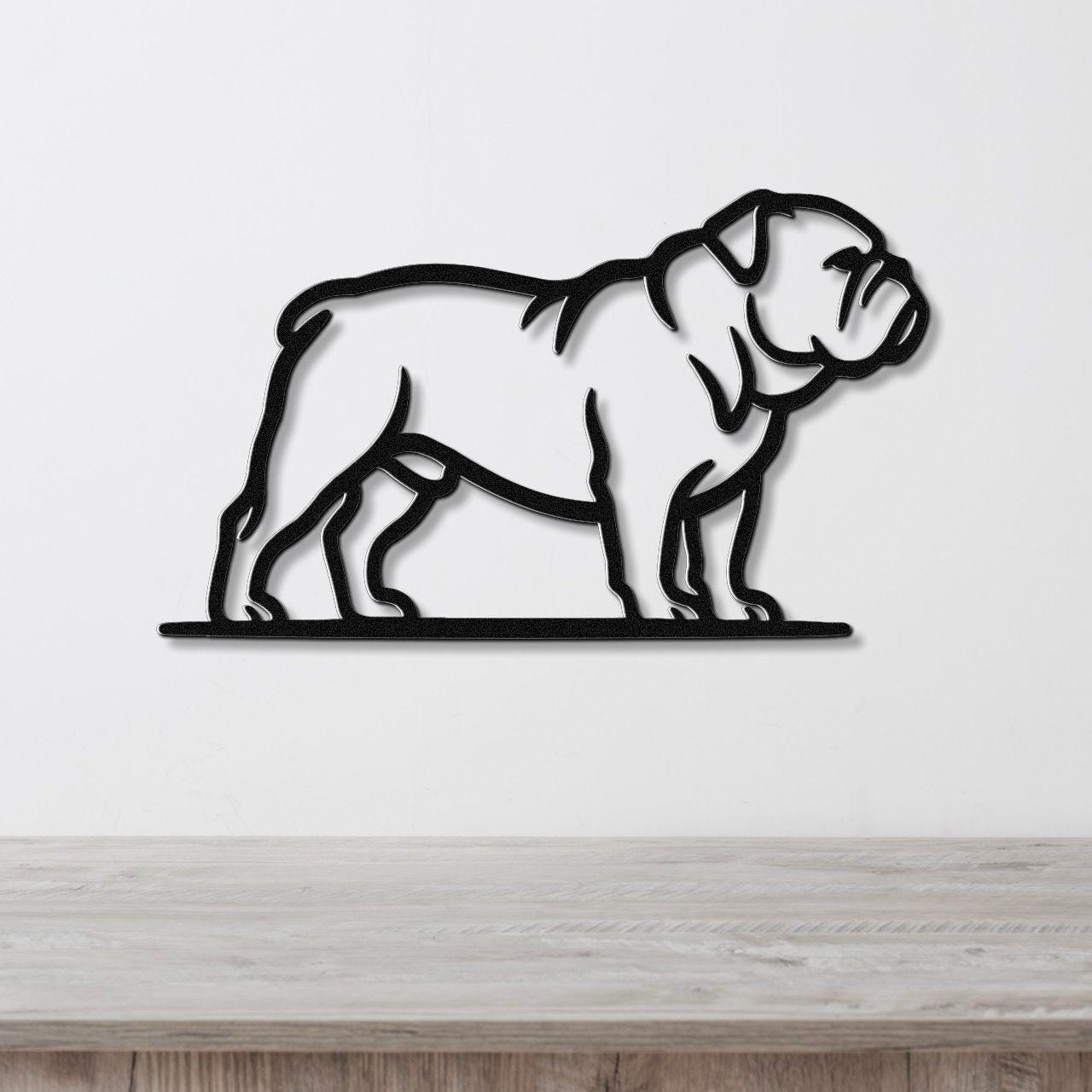 Black metal bulldog wall art with a bold silhouette and internal cutout details, mounted on a white wall above a light wood countertop.