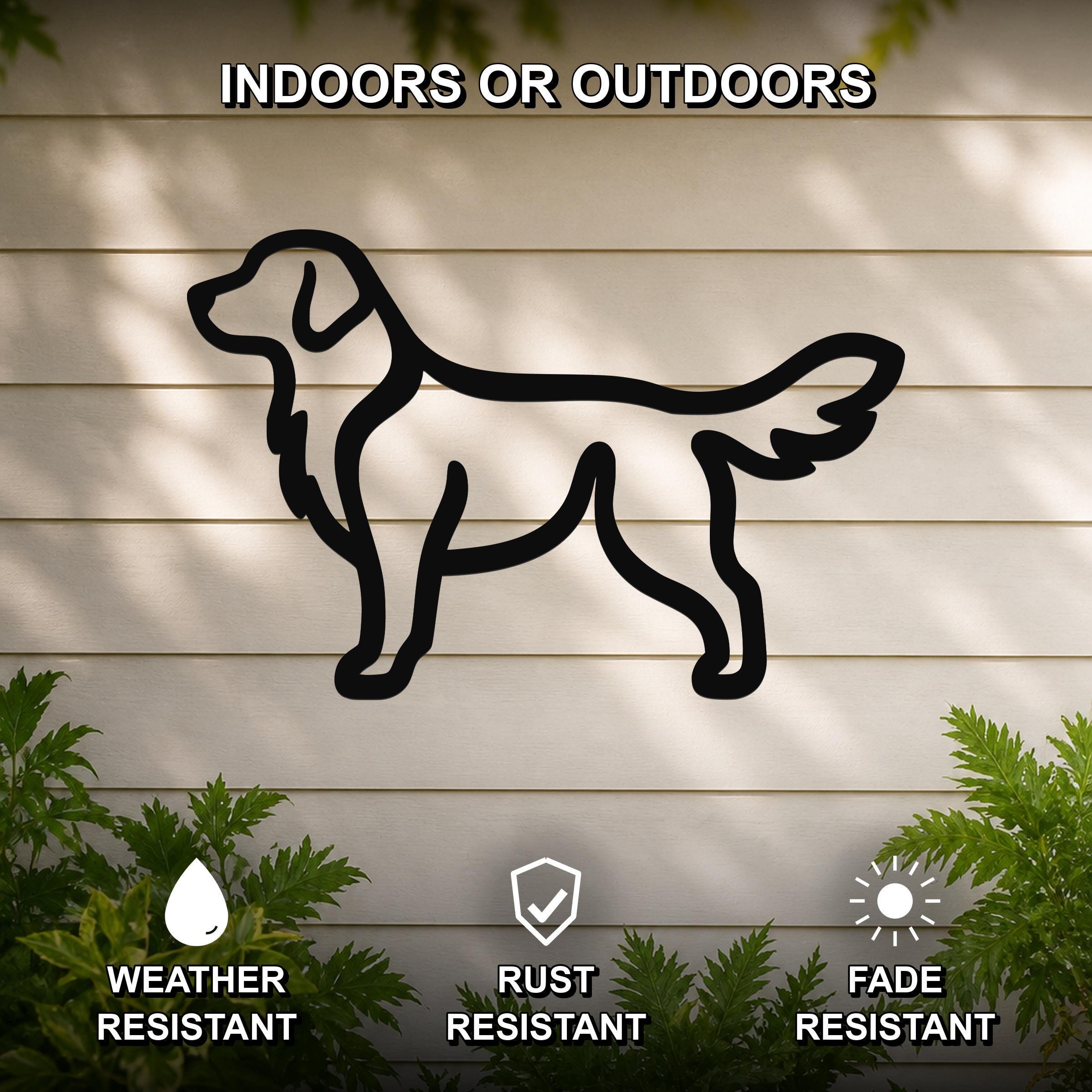 Black metal dog silhouette wall art of a golden retriever, mounted on a light-colored outdoor wall with greenery, weather resistant, rust resistant, and fade resistant.