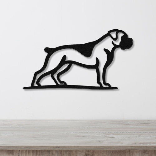 Black metal wall art silhouette of a boxer dog in profile, mounted on a white wall above a light wood surface.