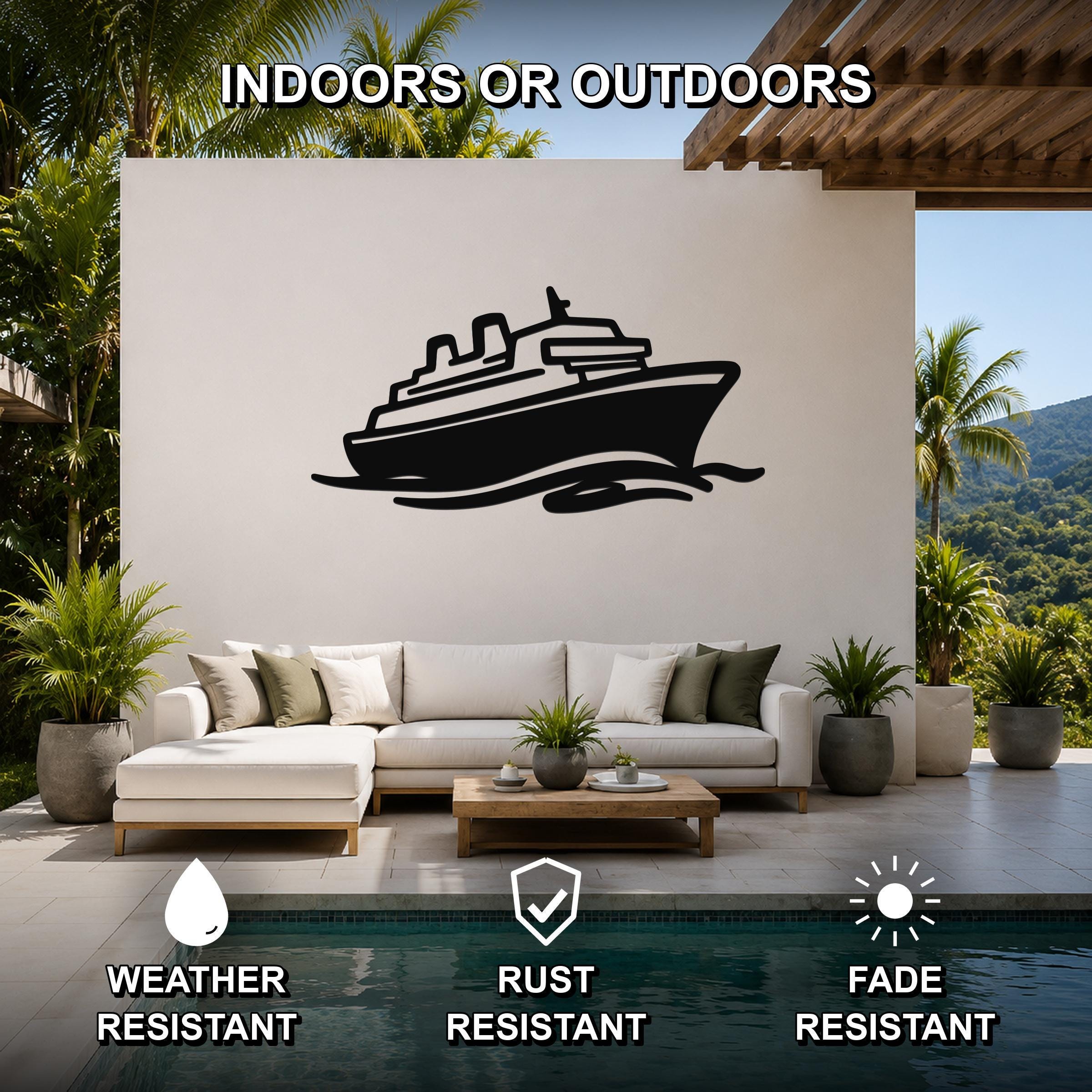 Black metal cruise ship wall art with wave cutouts, mounted on a white outdoor wall above a sofa in a patio living area.