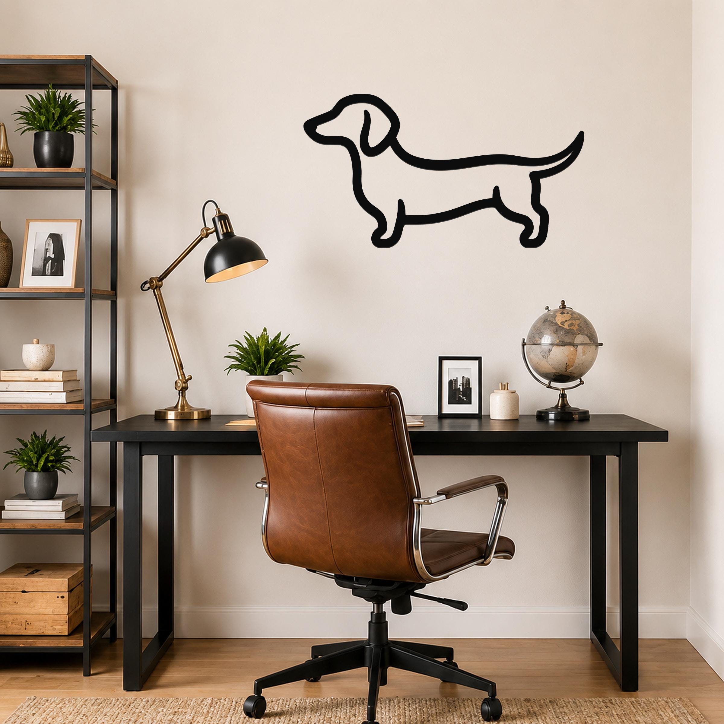 Black metal dachshund wall art in a bold silhouette style, mounted on a wall above a black desk in a home office.
