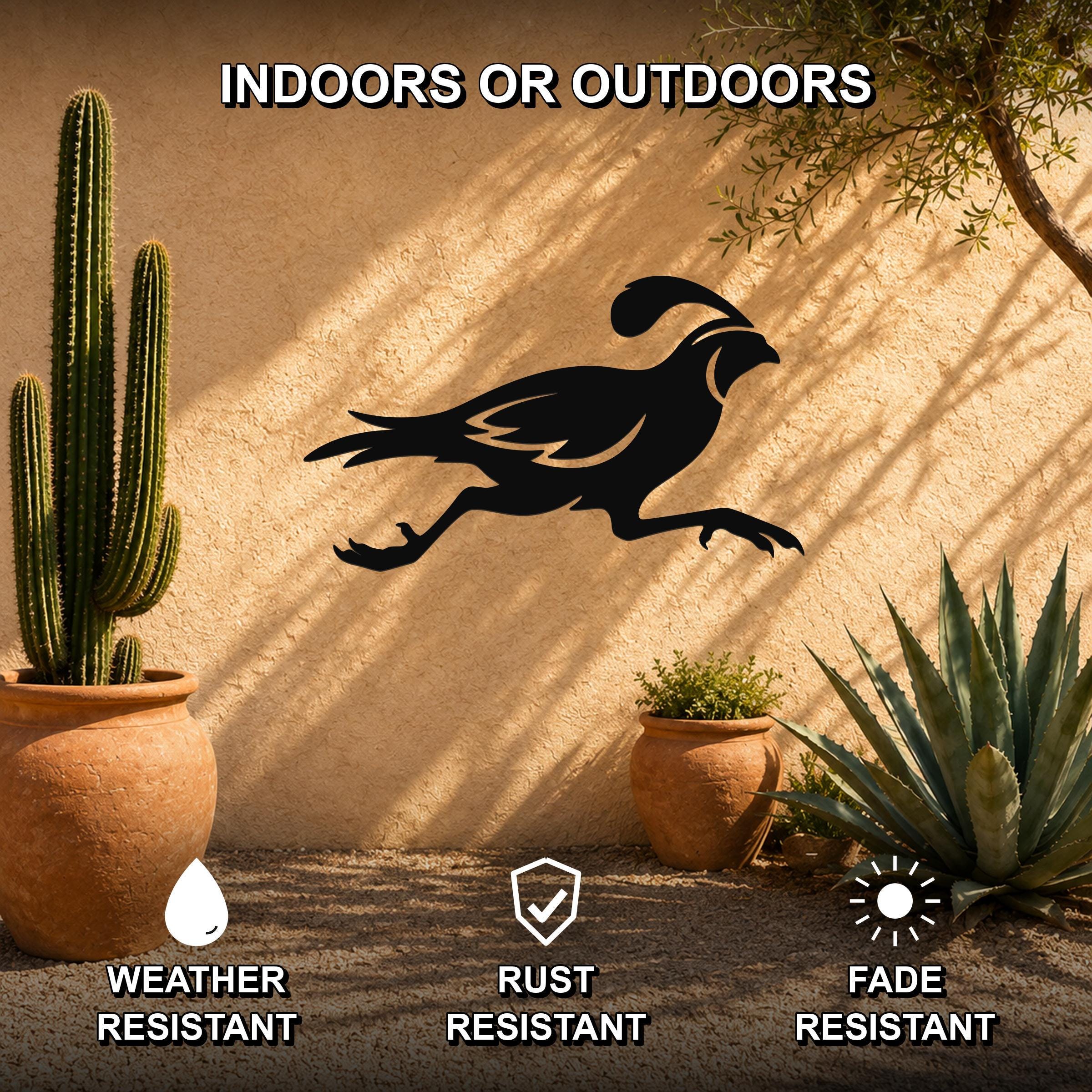 Black metal quail wall art silhouette with motion-line cutouts, mounted on an outdoor stucco wall between potted cacti and succulents.