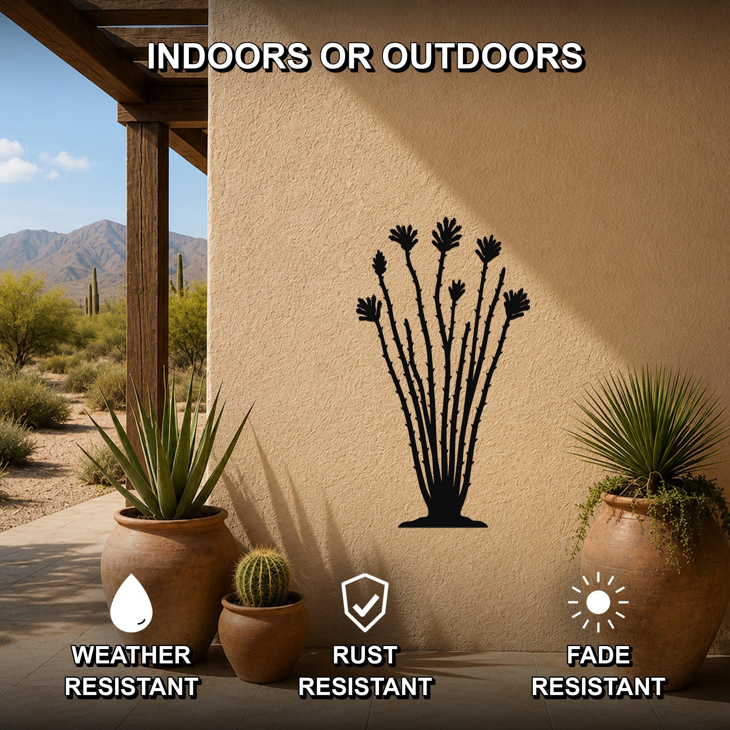 Black metal ocotillo wall sculpture with spiny branches and leafy tops, mounted on a stucco outdoor wall beside potted plants, weather resistant and fade resistant.