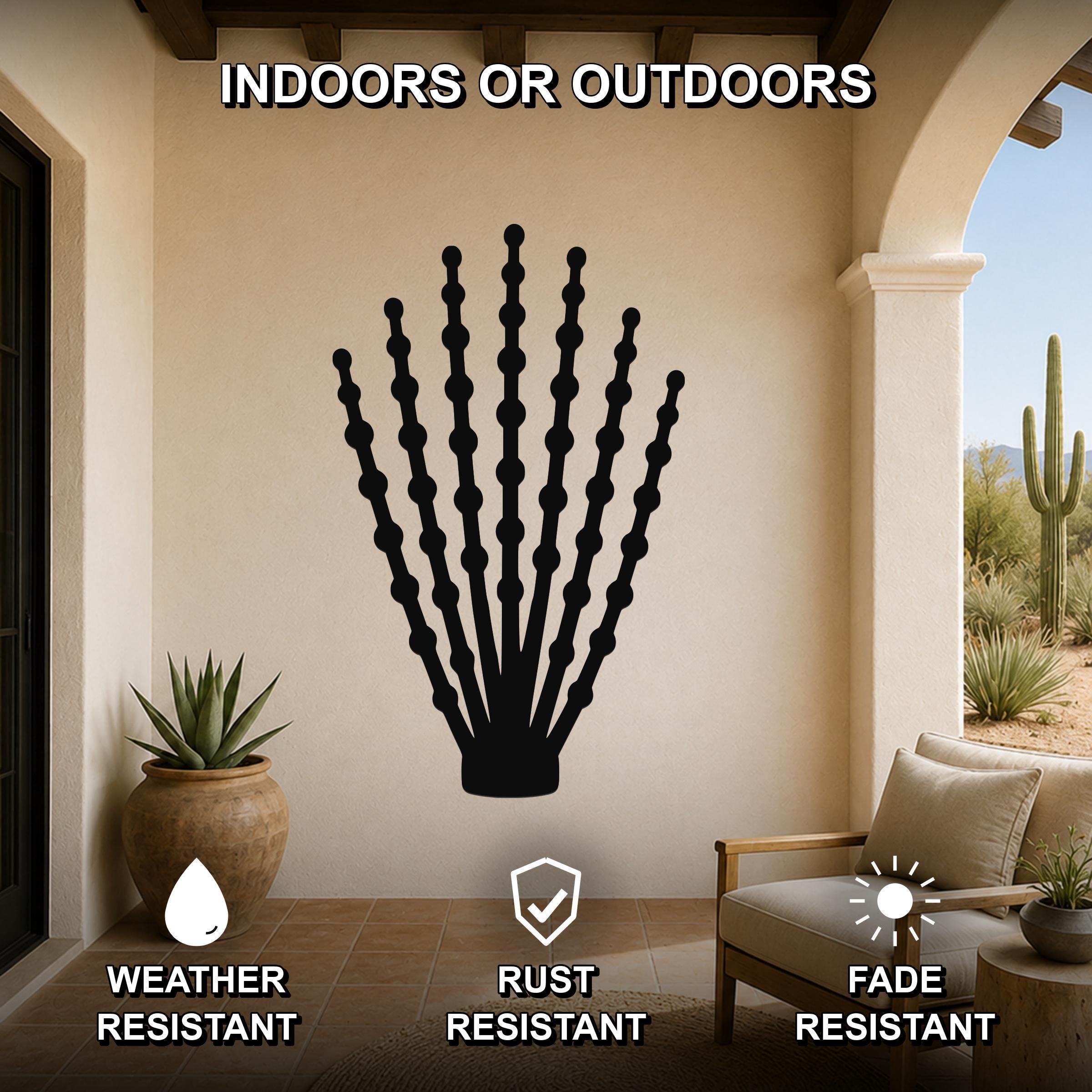 Black metal ocotillo wall art with beaded branch cutouts, mounted on a beige patio wall above a chair, weather, rust, and fade resistant.