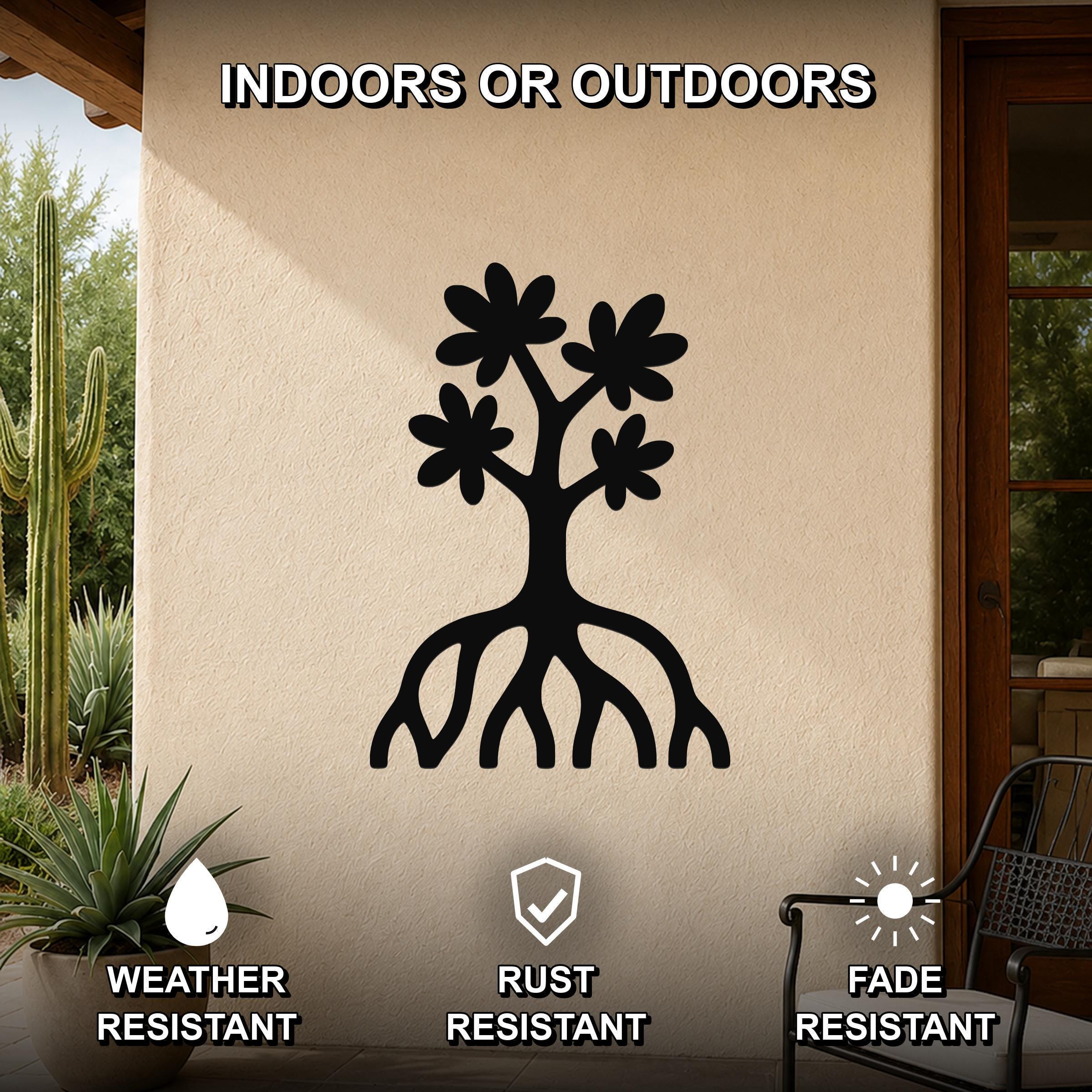 Black metal wall art featuring a tree silhouette with flower cutouts and visible roots, mounted on an outdoor patio wall.