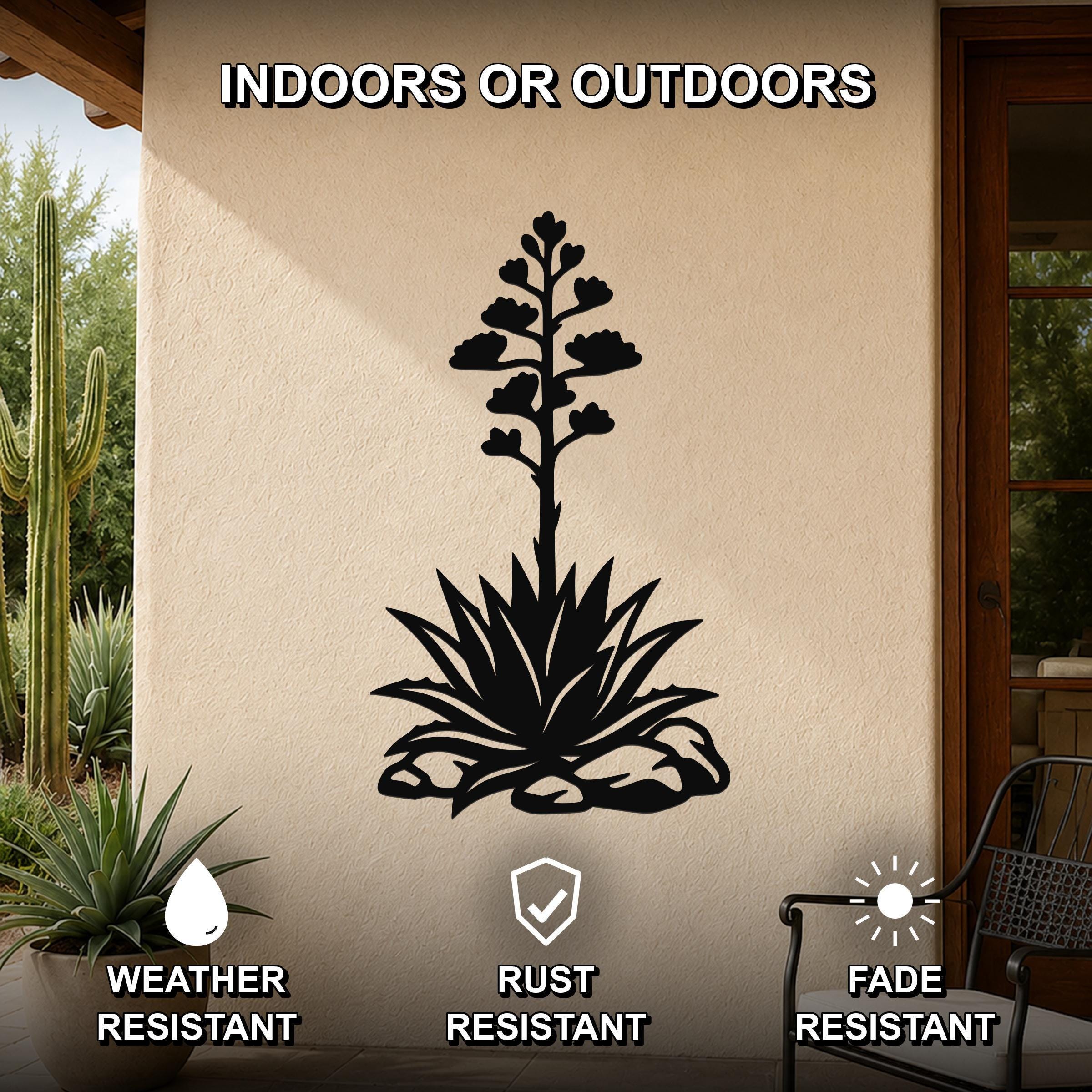 Black metal agave wall art with a blooming flower and spiky leaves cutout, mounted on an outdoor patio wall.