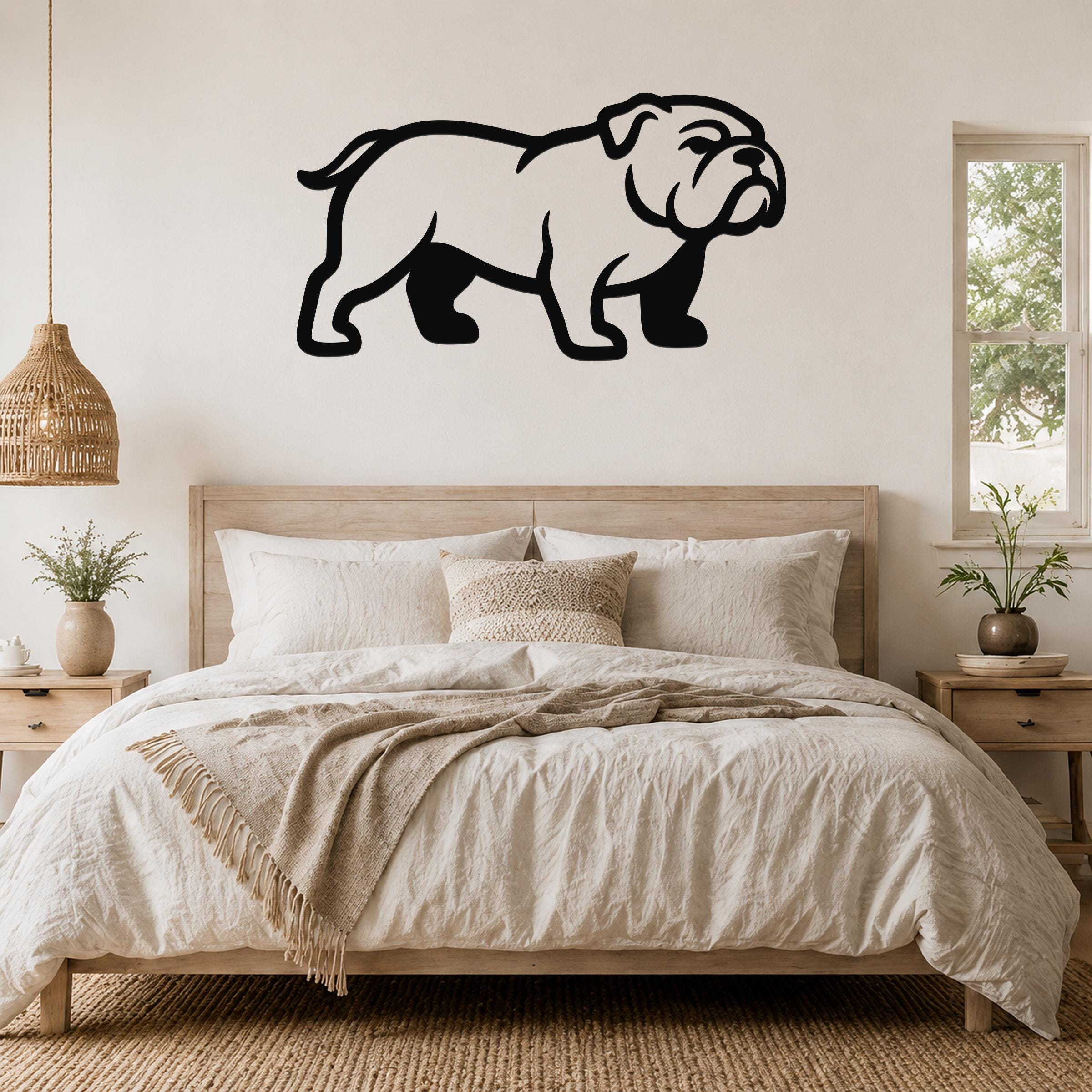 Black metal bulldog wall art silhouette mounted above a wooden bed in a neutral bedroom.