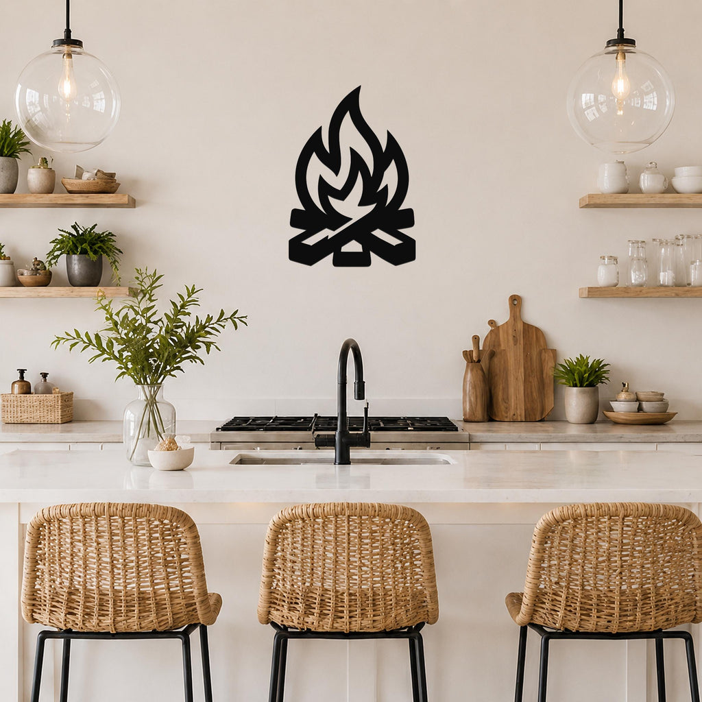 Black metal campfire wall art with flame and log silhouette, mounted on a kitchen wall above a counter.