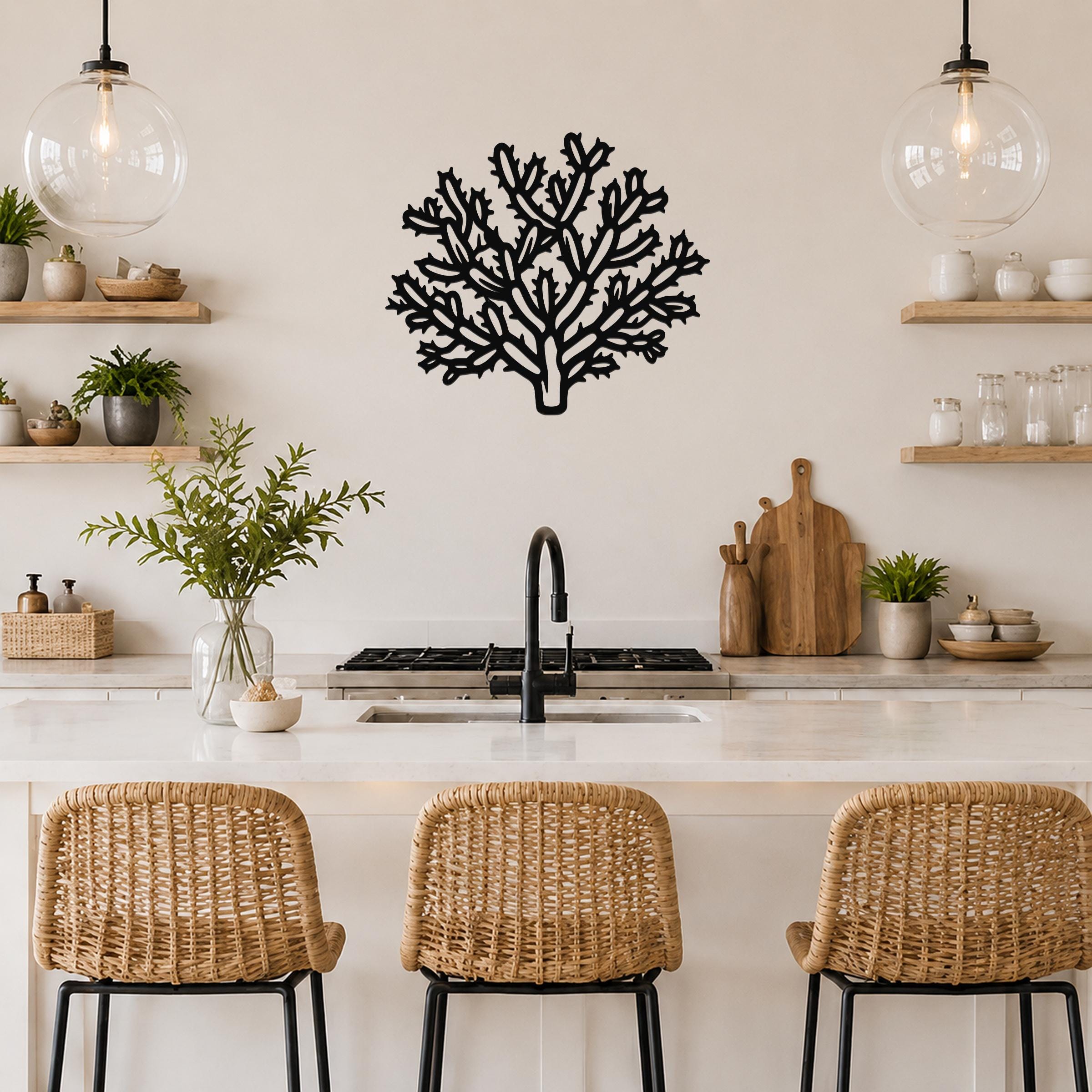 Black metal cholla cactus wall art with intricate branch cutouts, mounted on a kitchen wall above a counter.