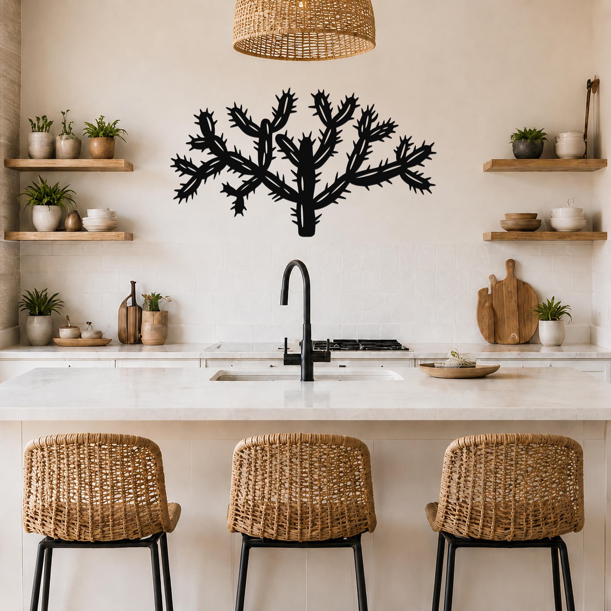 Black metal Cholla cactus wall art with detailed spine cutouts, mounted on a kitchen wall above a counter.