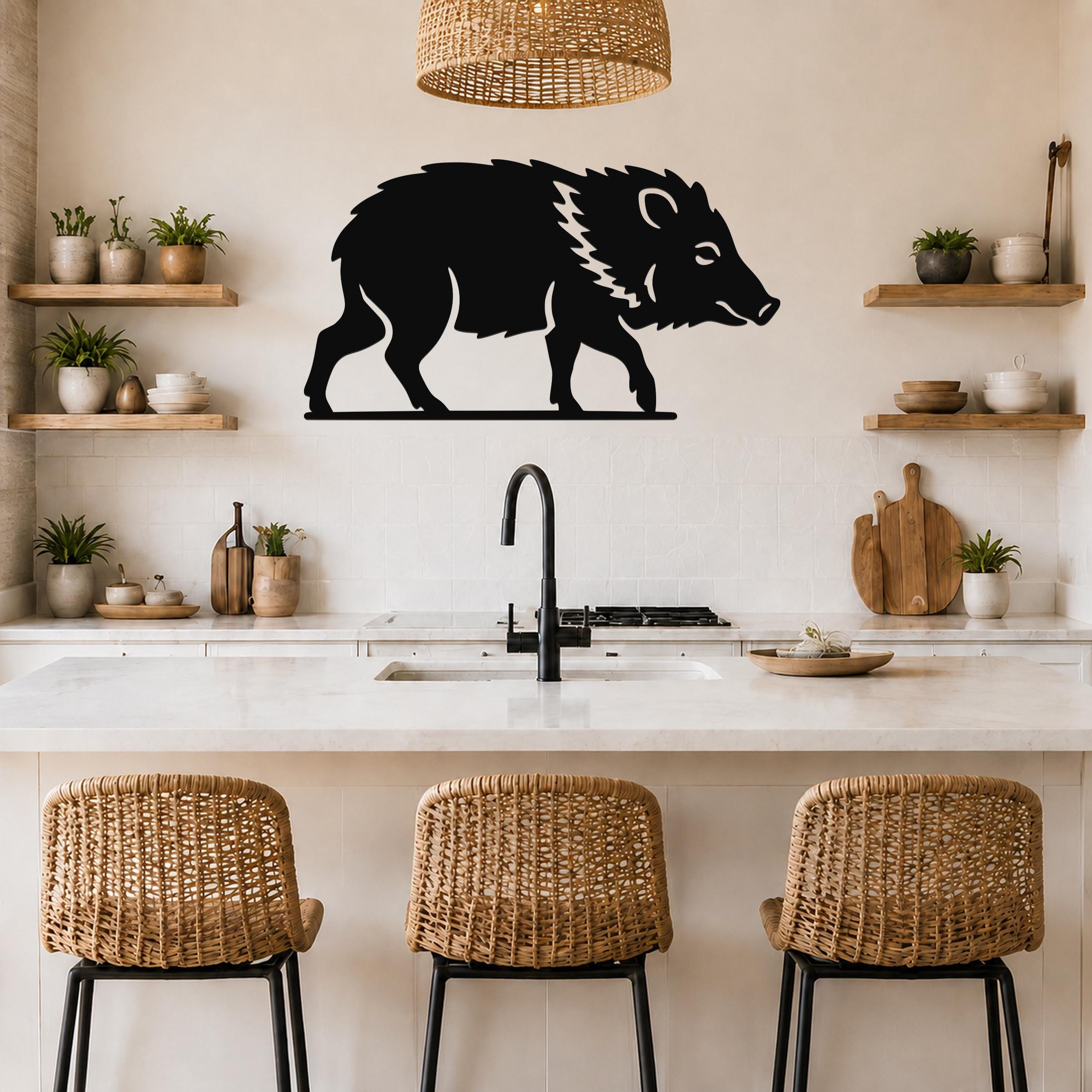 Black metal javelina wall art silhouette with white line details, mounted on a kitchen wall above a counter.