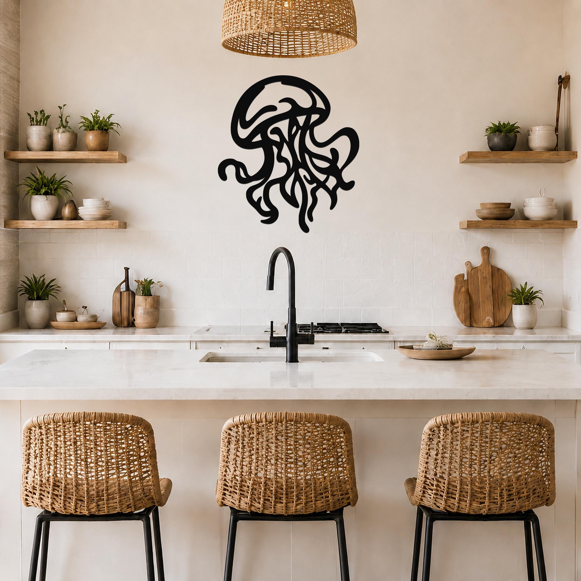 Black metal jellyfish wall art with flowing tentacle cutouts, mounted on a kitchen wall above a counter.