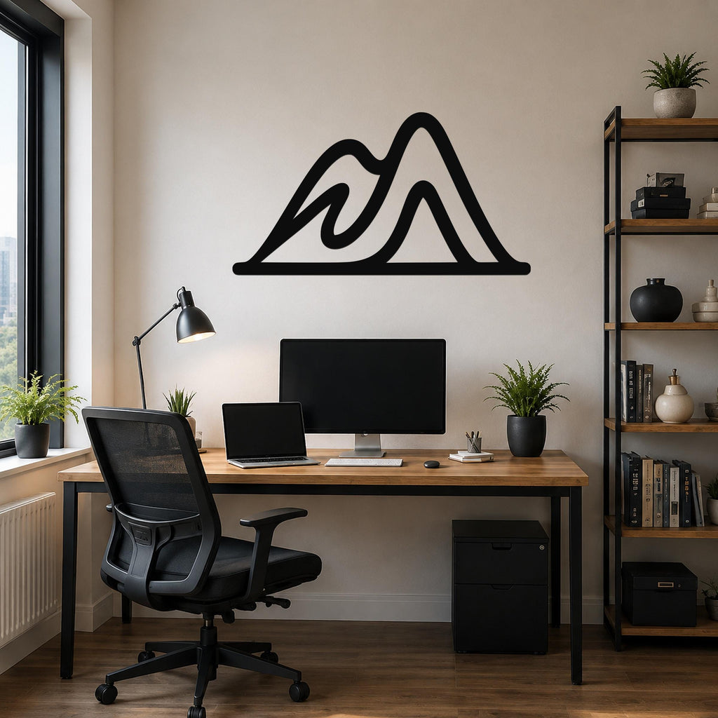 Black metal mountain silhouette wall art with layered peaks, mounted above a wooden desk in a modern home office.