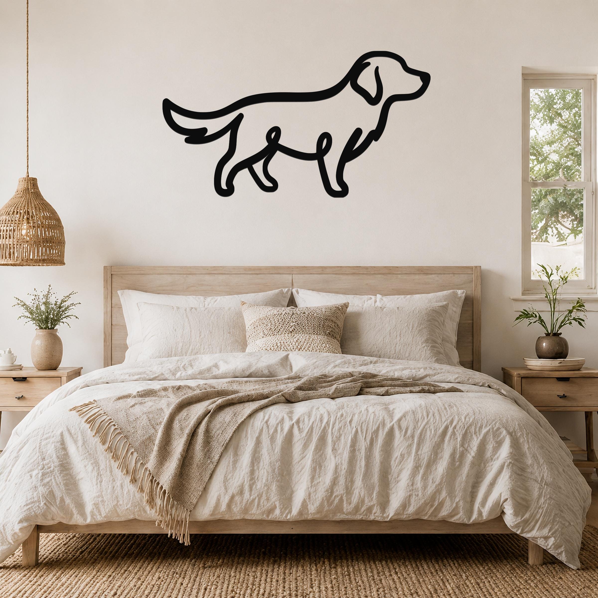 Black metal dog silhouette wall art, a bold outline of a standing dog, mounted above a wooden bed in a neutral bedroom.