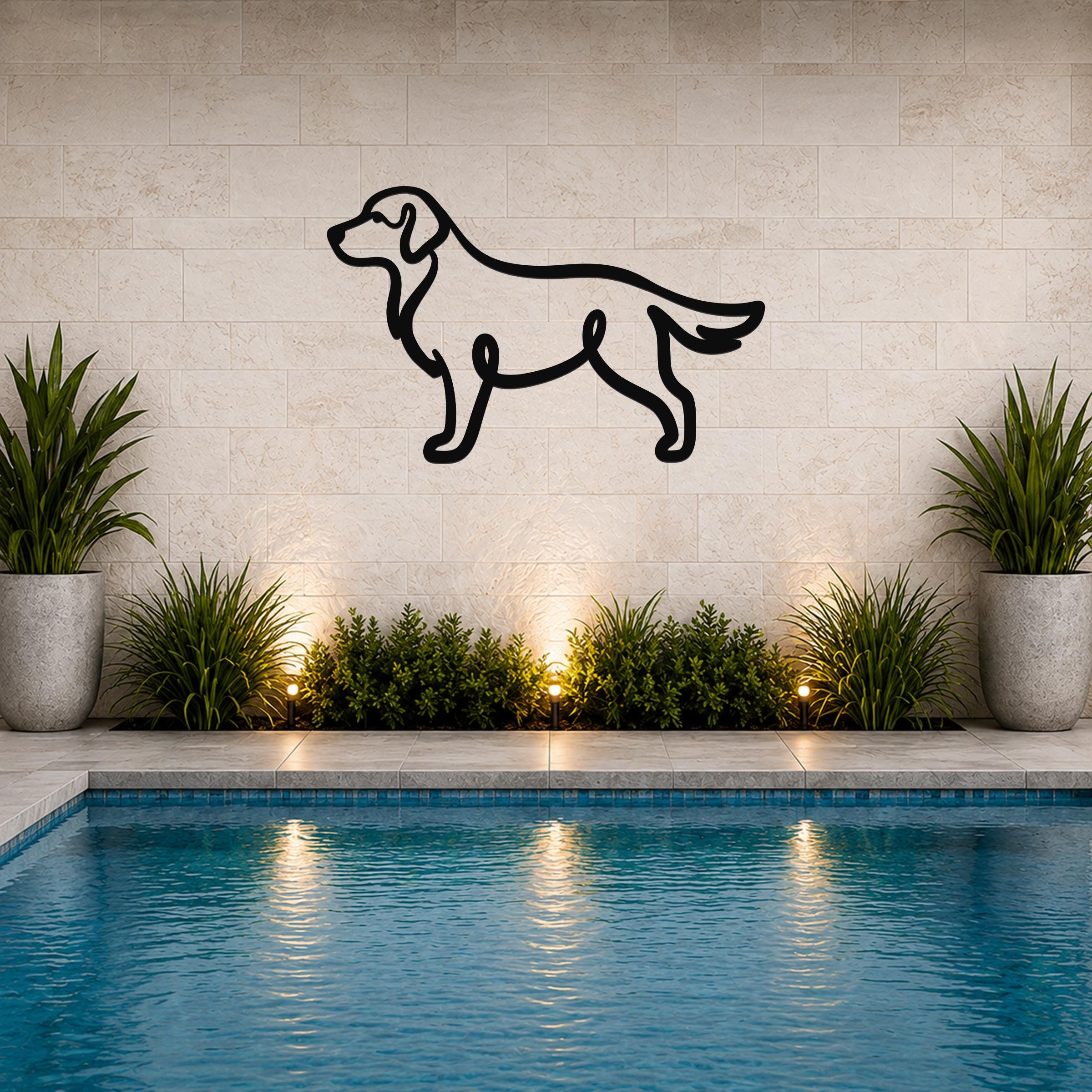 Black metal dog silhouette wall art mounted on a tiled wall above a pool, with potted plants and ground lights below.