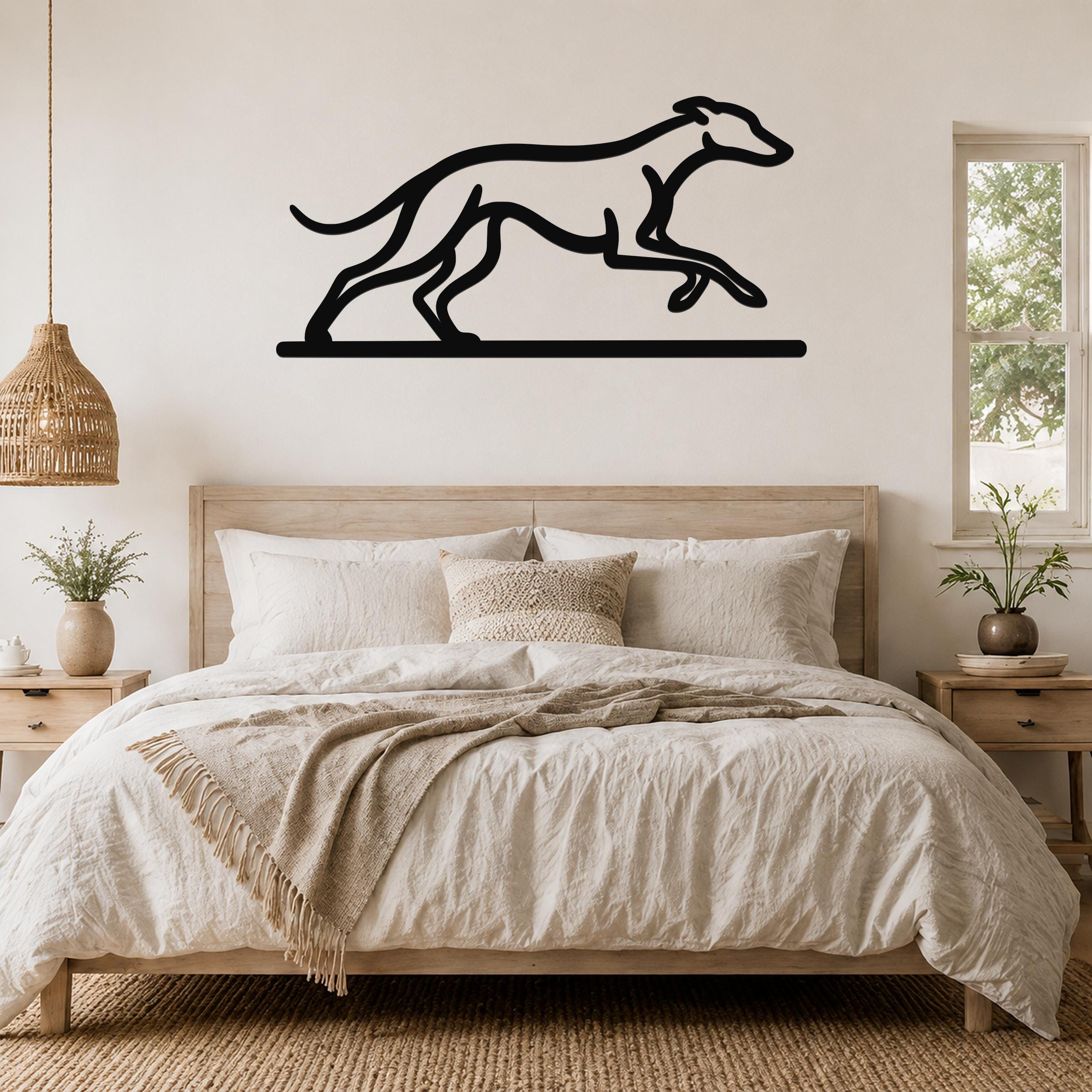 Black metal greyhound wall art with a running silhouette, mounted above a bed in a neutral bedroom.