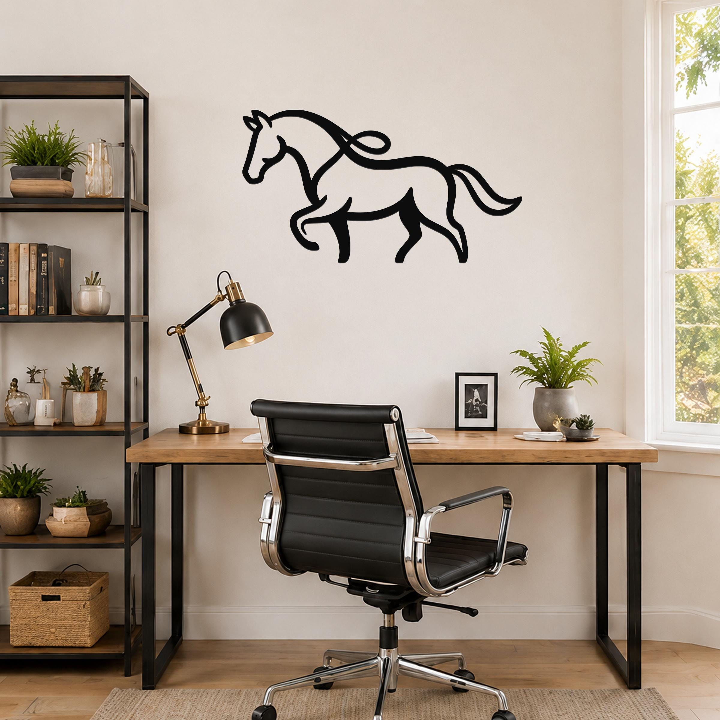 Black metal horse wall art with flowing mane and tail silhouette, mounted above a wooden desk in a home office.