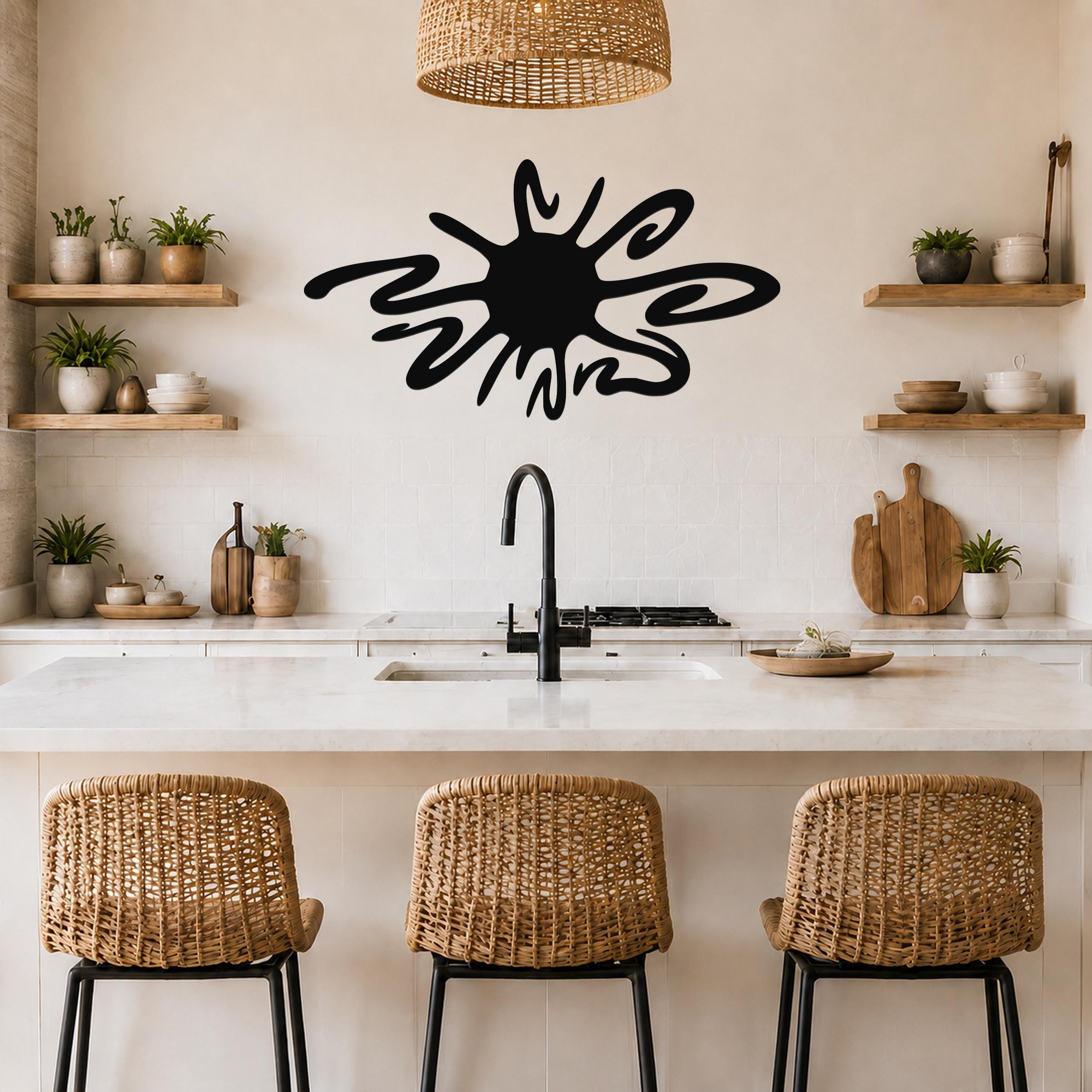 Black metal sea urchin wall art with spiky, organic cutouts, mounted on a kitchen wall above a counter.