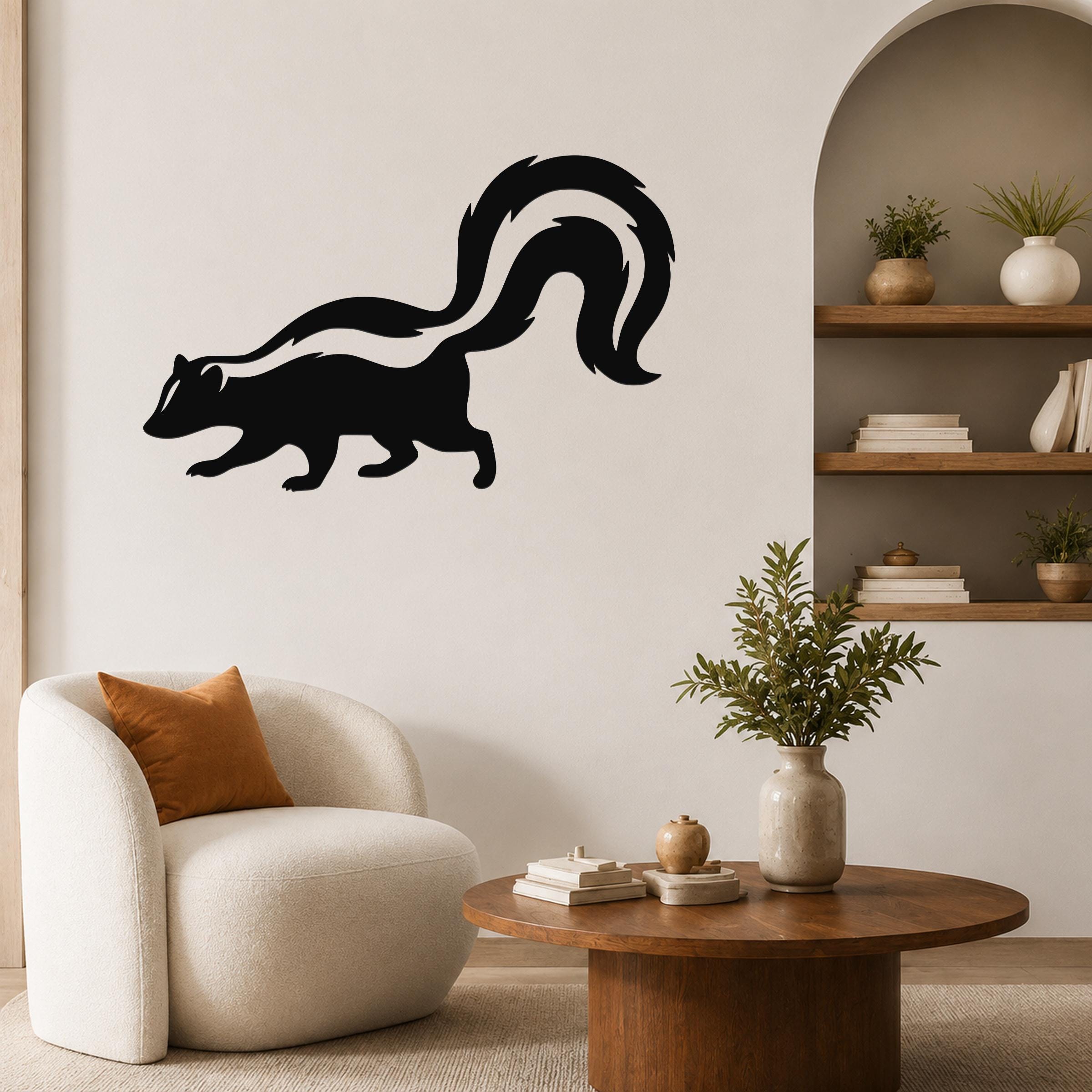 Black metal skunk wall art silhouette with a curved tail, mounted on a living room wall above a round wooden coffee table.