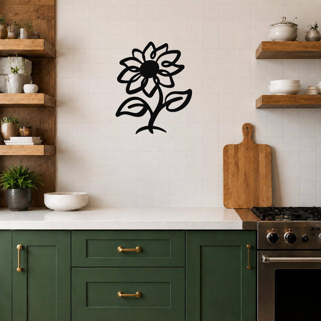 Black metal sunflower wall art with cutout petals and leaves, mounted on a tiled kitchen wall above a counter.