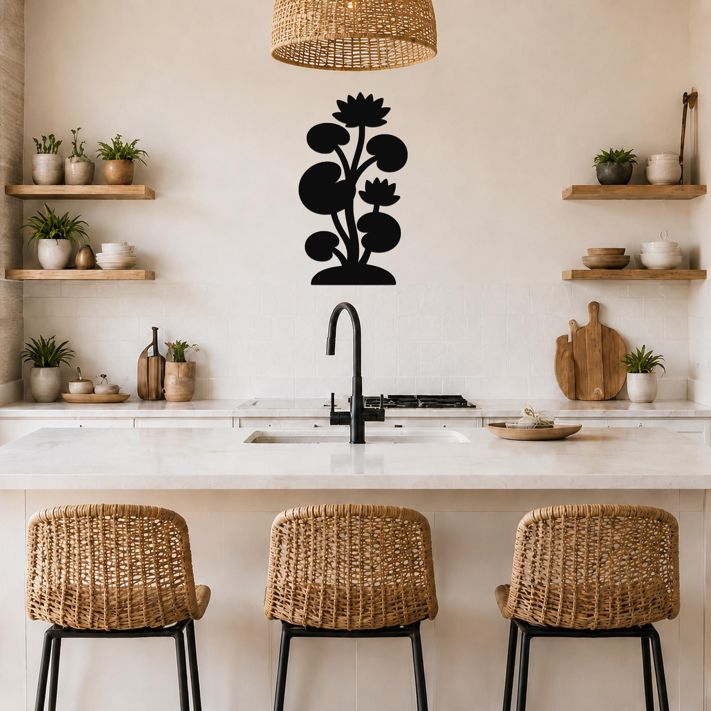 Black metal lotus water lily wall art with layered flower and leaf cutouts, mounted on a kitchen wall above a counter.