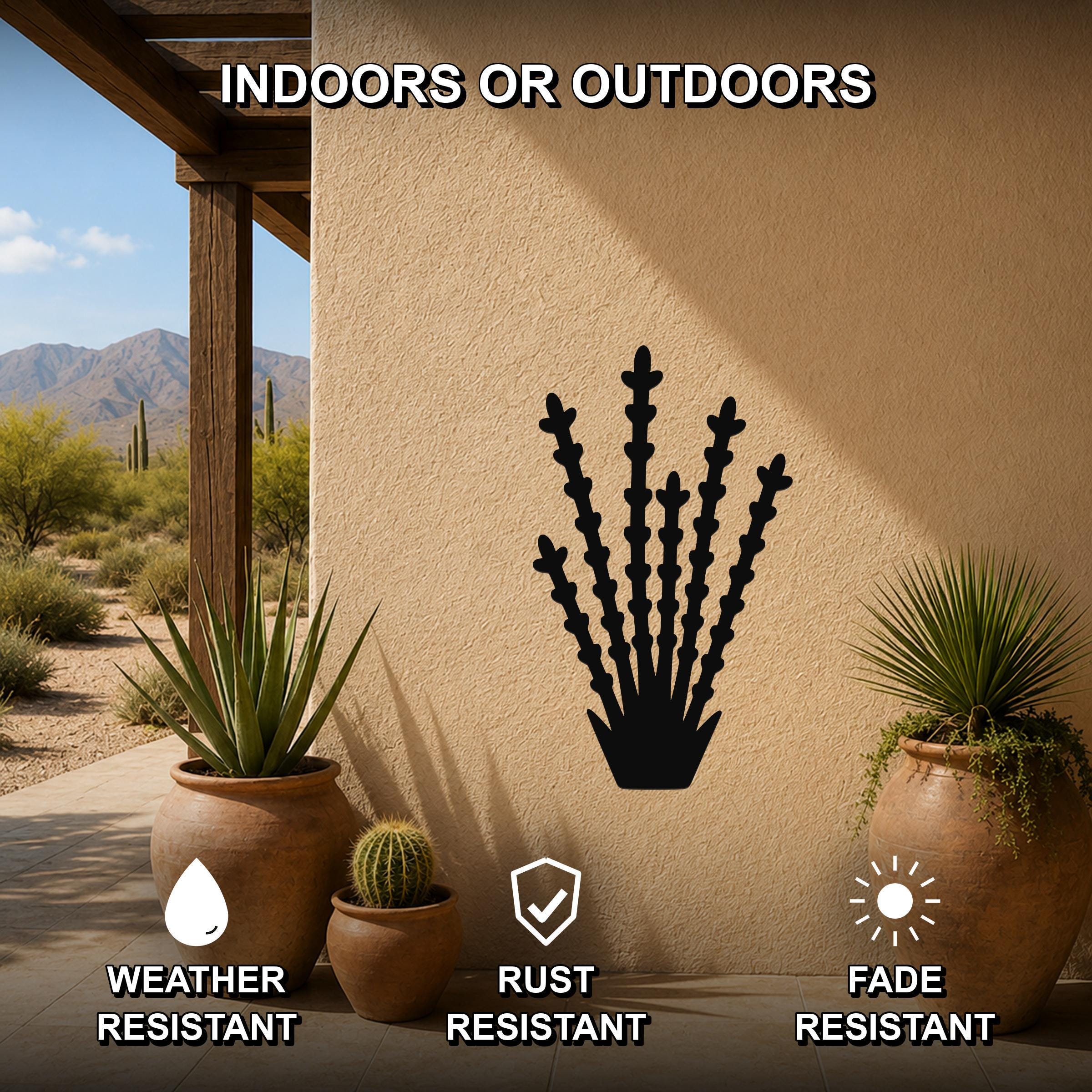 Black metal ocotillo wall art silhouette mounted on a stucco outdoor wall, displayed on a patio with potted plants and desert scenery in the background.