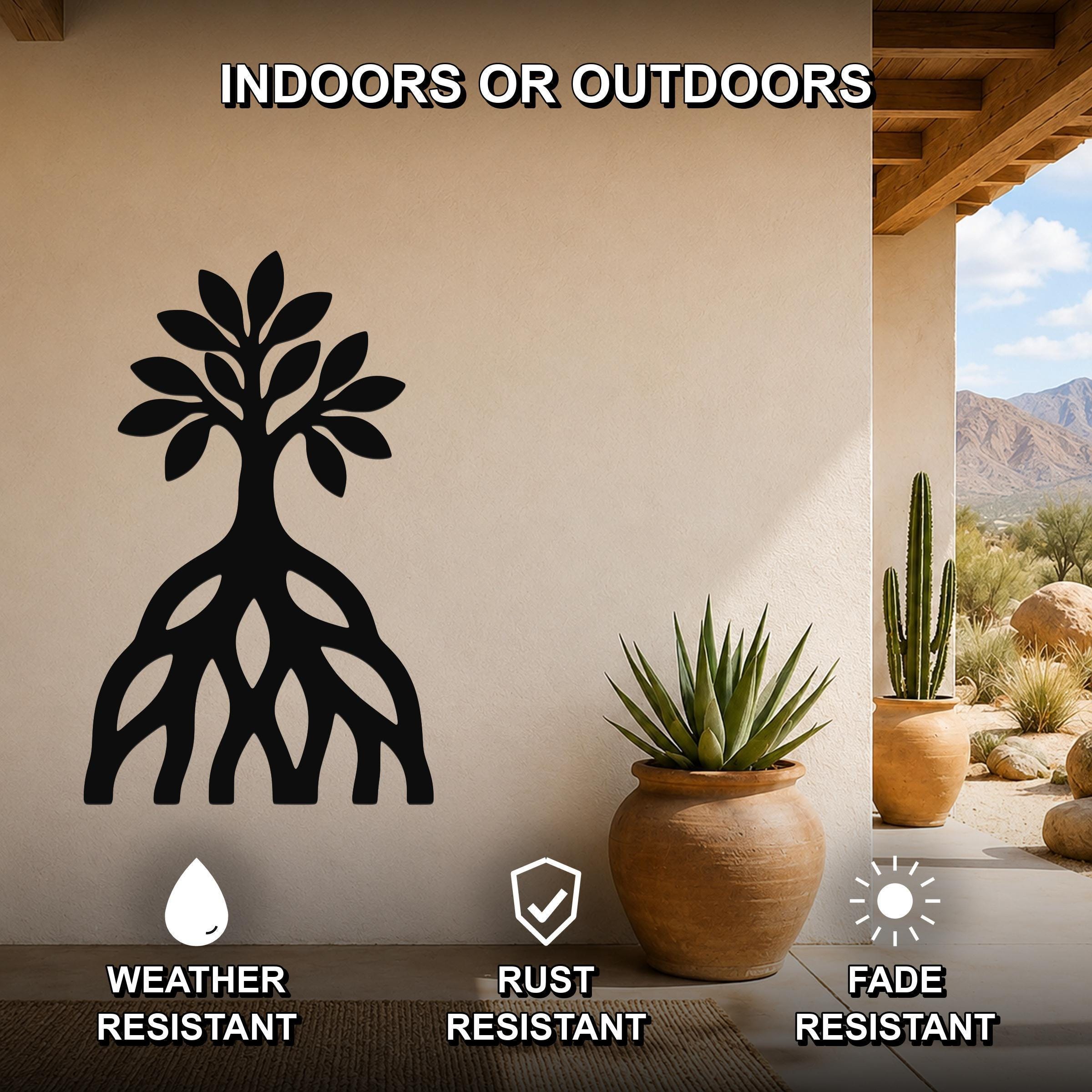 Black metal wall art silhouette of a mangrove tree with visible root system, mounted on a beige outdoor wall above a potted succulent on a patio.