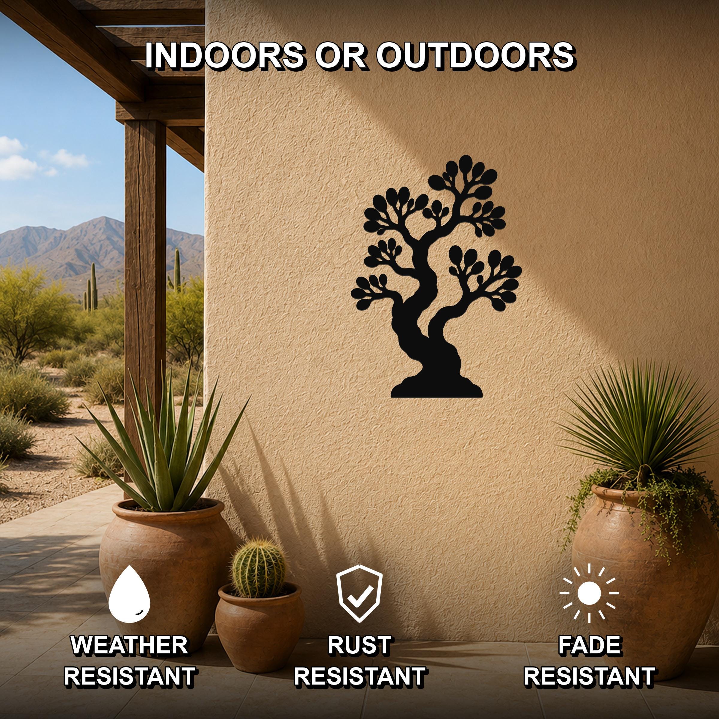 Black metal bonsai tree wall art with detailed branch cutouts, mounted on an outdoor patio wall above potted plants, weather, rust, and fade resistant.