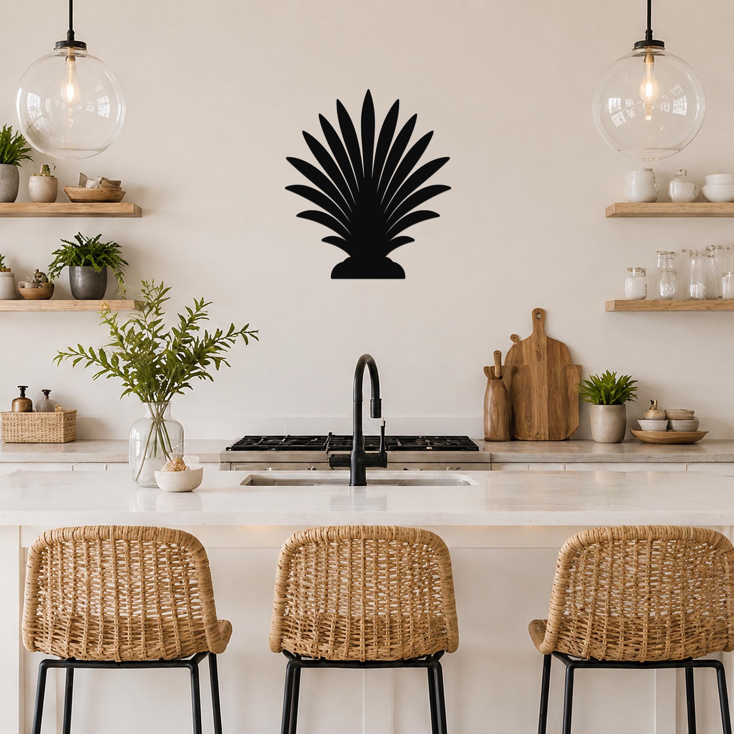 Black metal palm tree wall art with fan-shaped fronds, mounted on a kitchen wall above a counter.