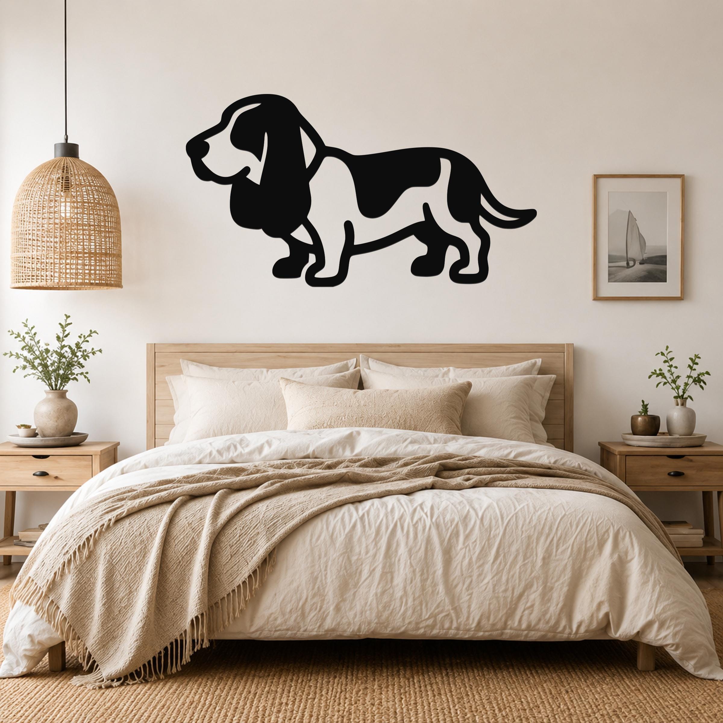 Black metal Basset Hound silhouette wall art mounted above a bed in a neutral bedroom.