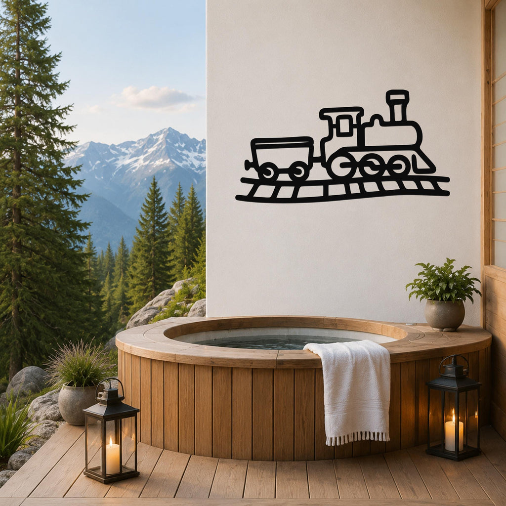 Black metal train wall art with a classic locomotive and car silhouette, mounted on a white wall above a wooden hot tub on a mountain-view deck.
