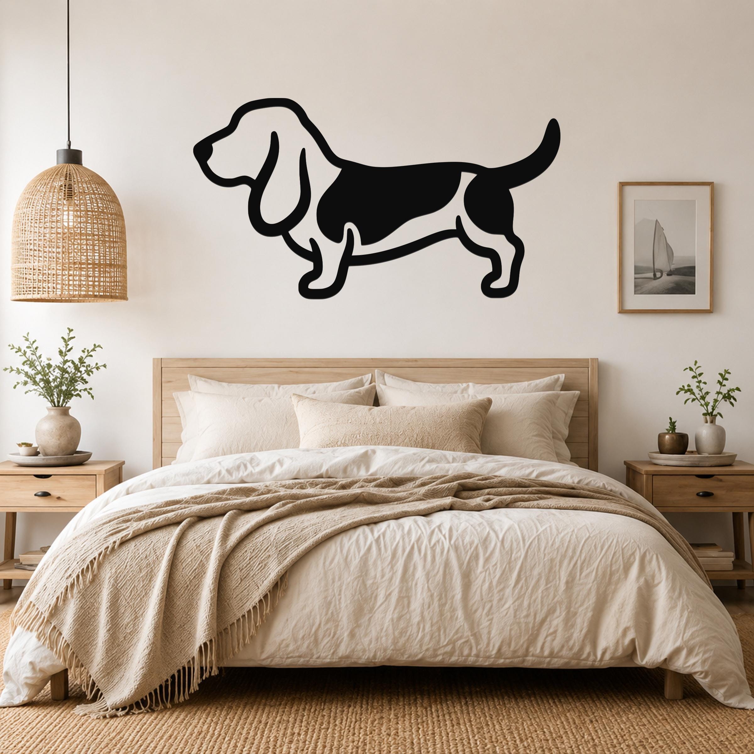 Black metal Basset Hound silhouette wall art mounted above a wooden bed in a neutral bedroom.