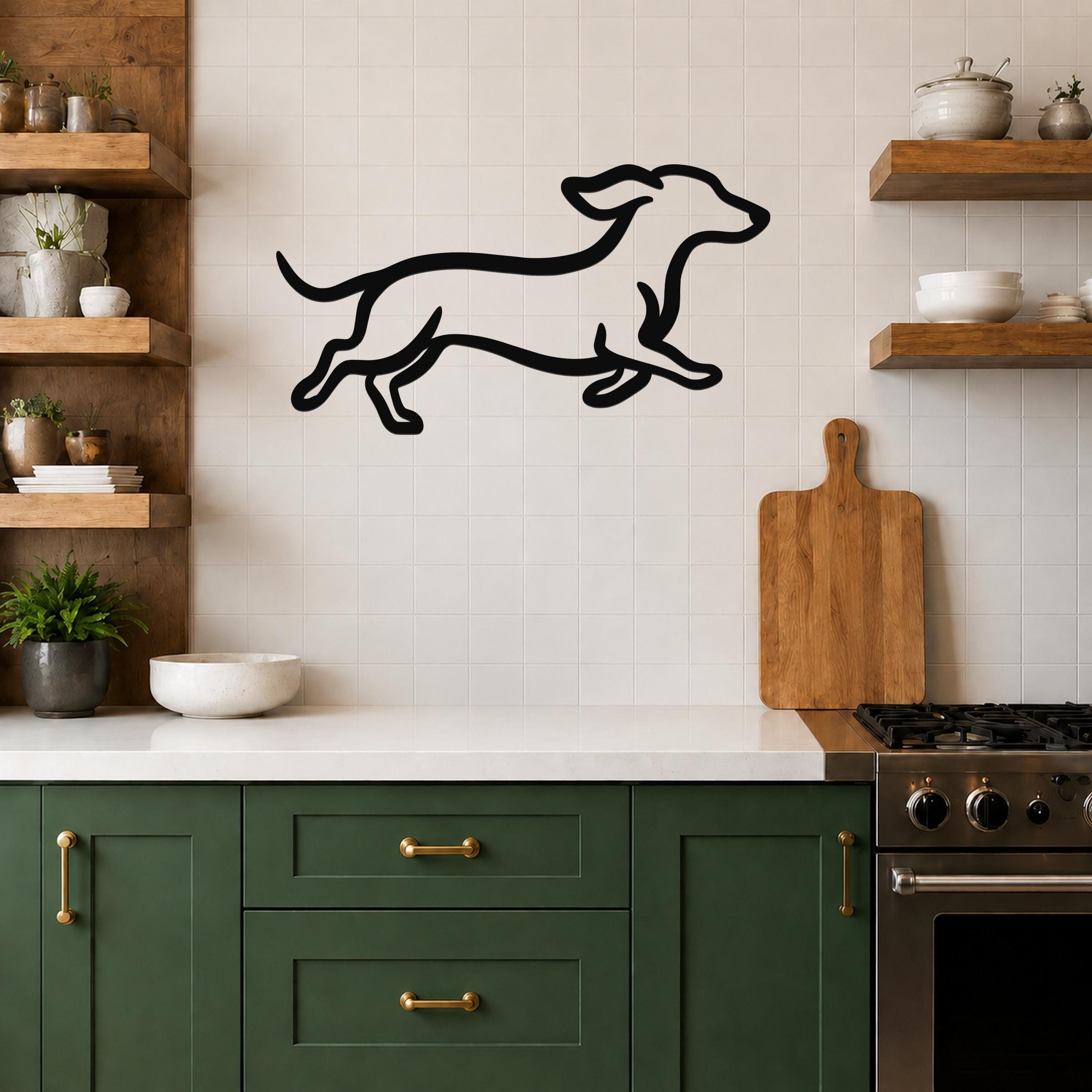 Black metal dachshund wall art with a running silhouette, mounted on a tiled kitchen wall above a counter.
