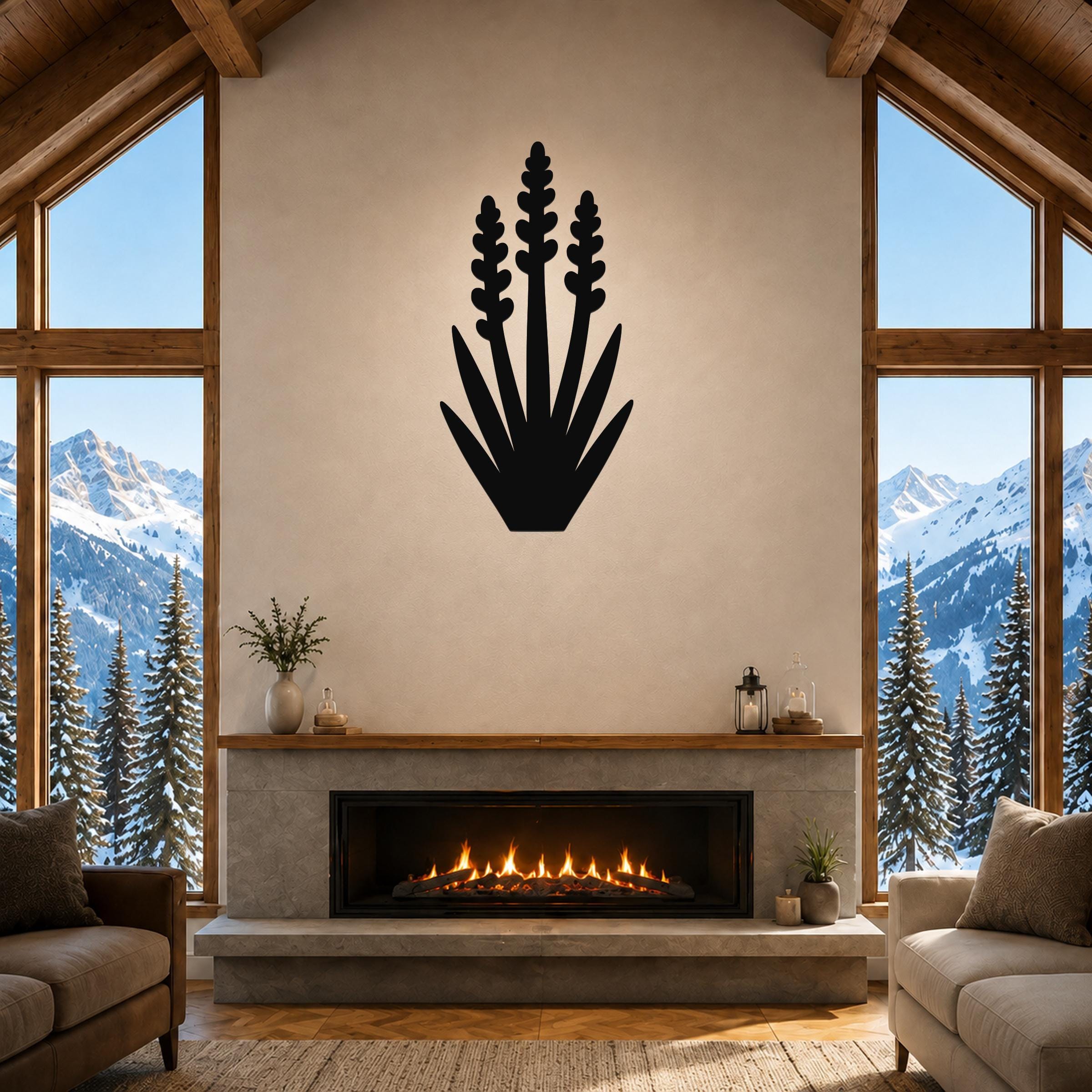 Black metal yucca wall art with layered leaf and bloom cutouts, mounted above a fireplace in a rustic living room with mountain views.