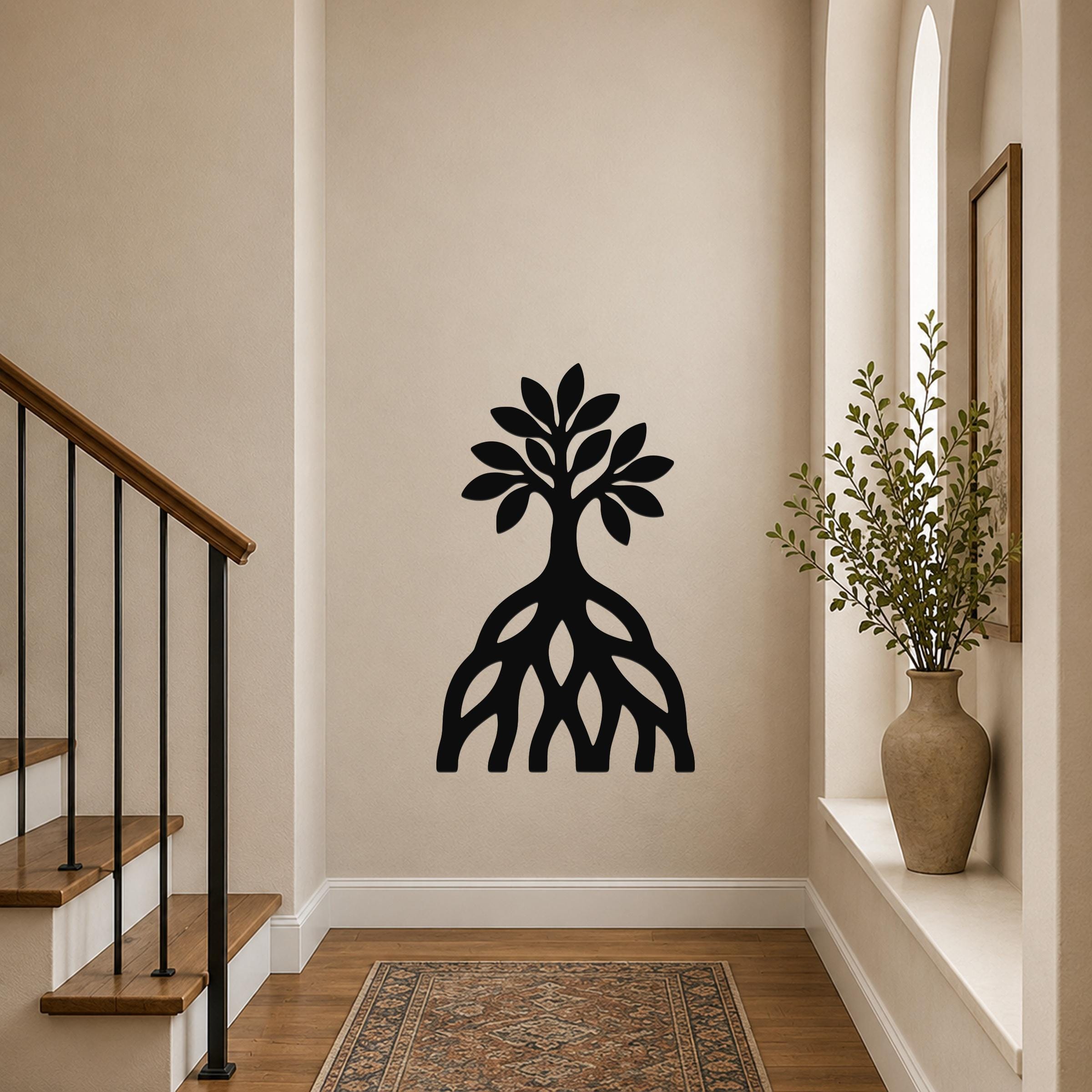 Black metal wall art silhouette of a mangrove tree with visible root system, mounted on a hallway wall near a staircase and window.