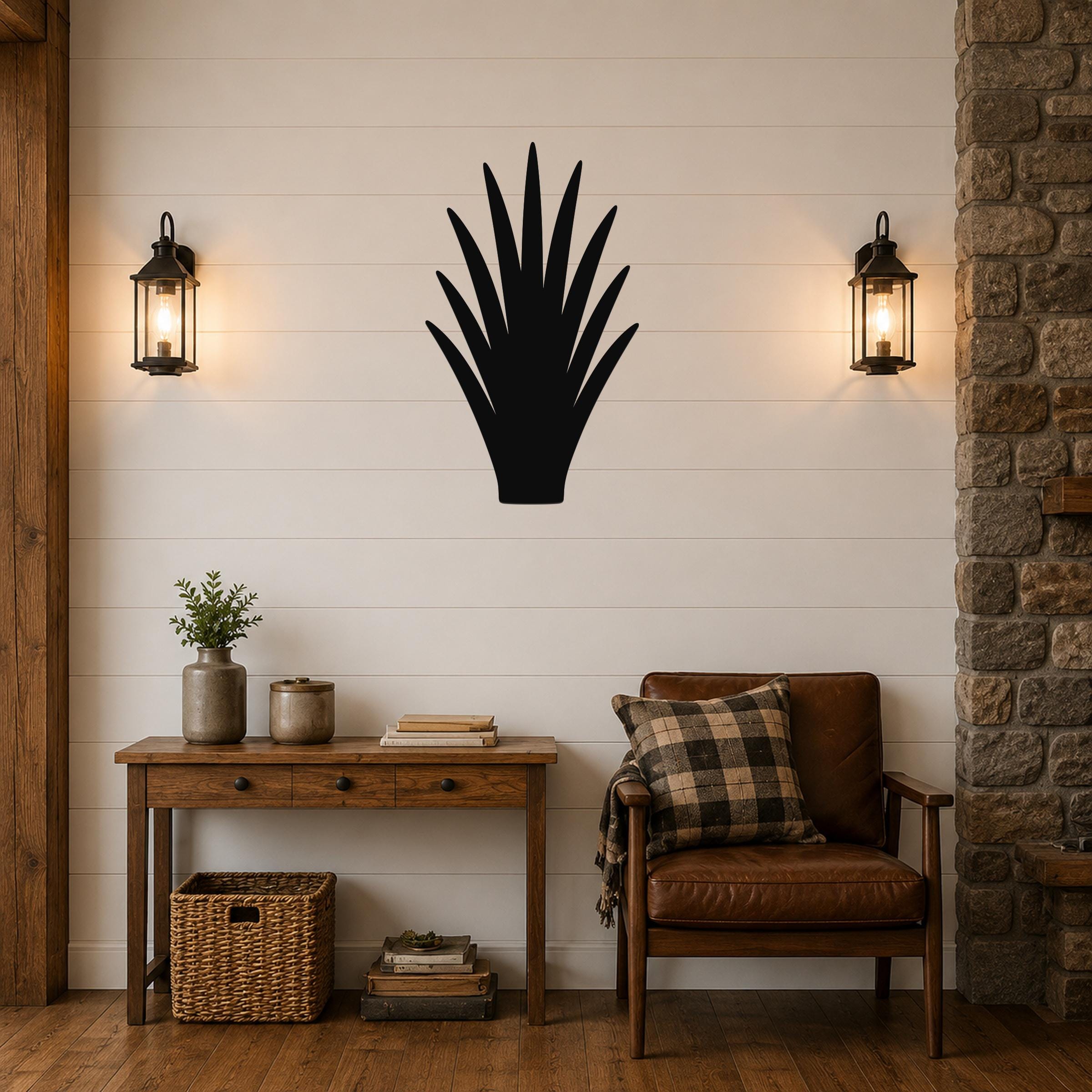 Black metal agave plant wall art silhouette mounted on a shiplap wall above a wooden console table in a living room.