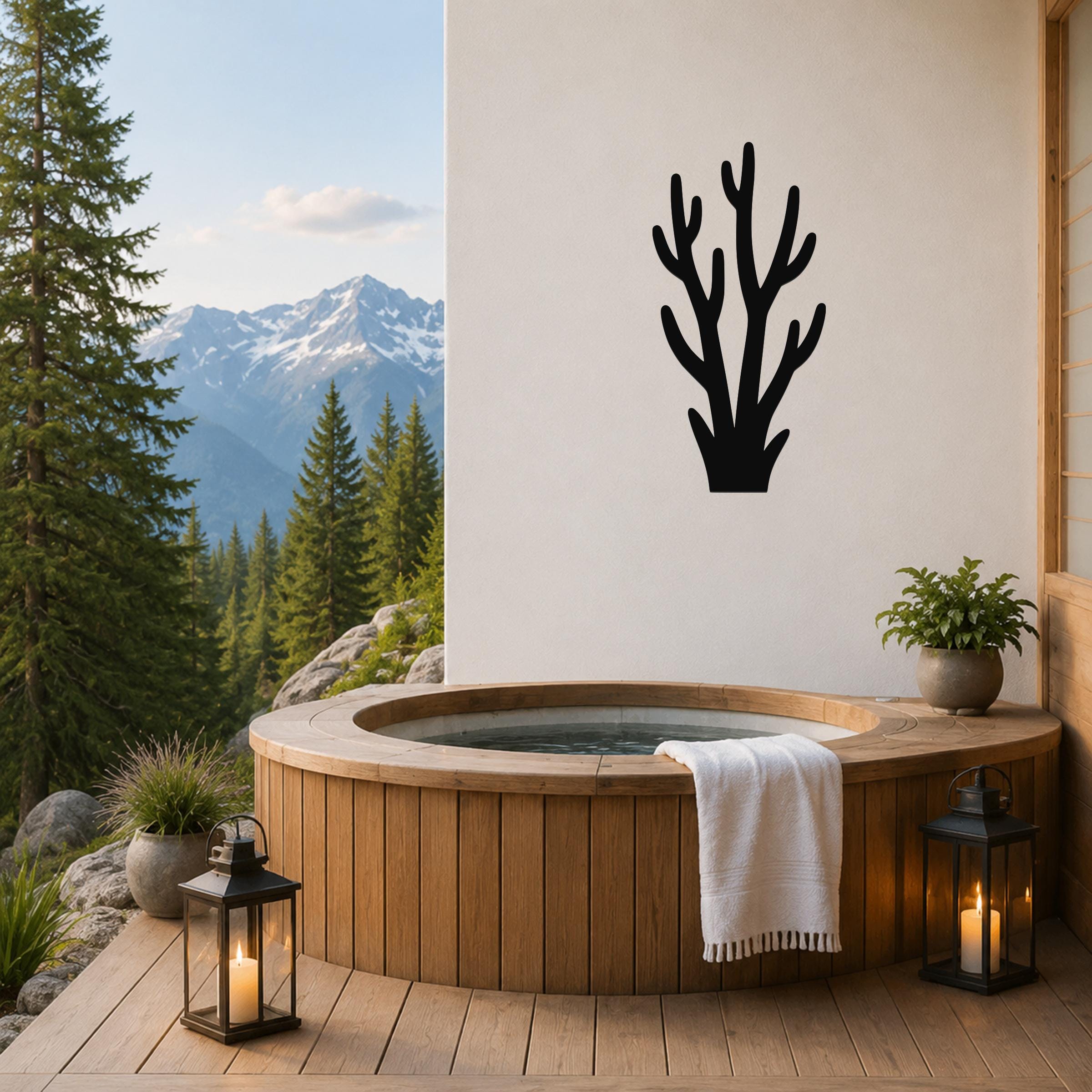 Black metal wall art in a coral branch silhouette, mounted on a white wall above a wooden hot tub on a mountain-view deck.