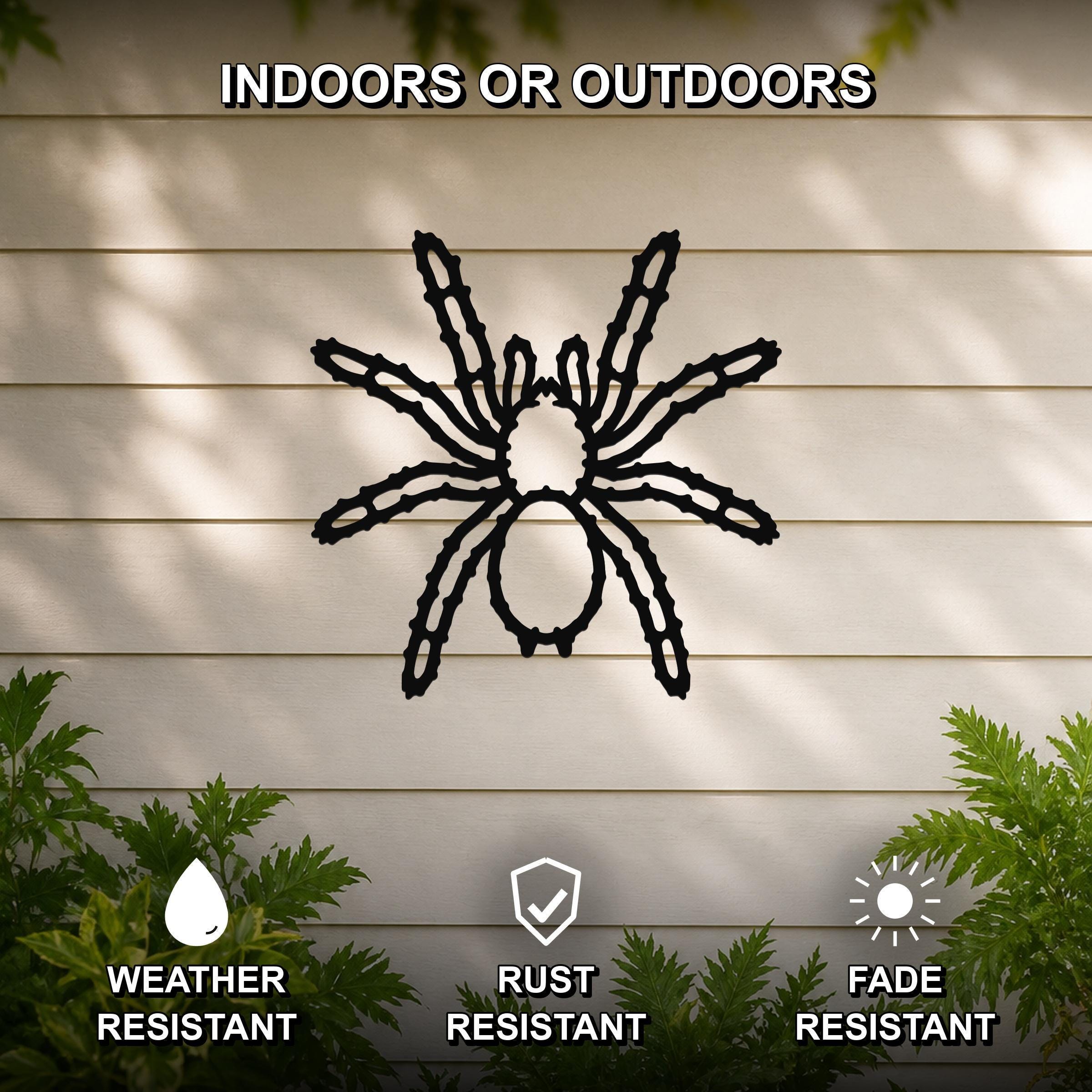Black metal spider wall art with detailed leg cutouts, mounted on a beige outdoor wall with greenery, weather, rust, and fade resistant.