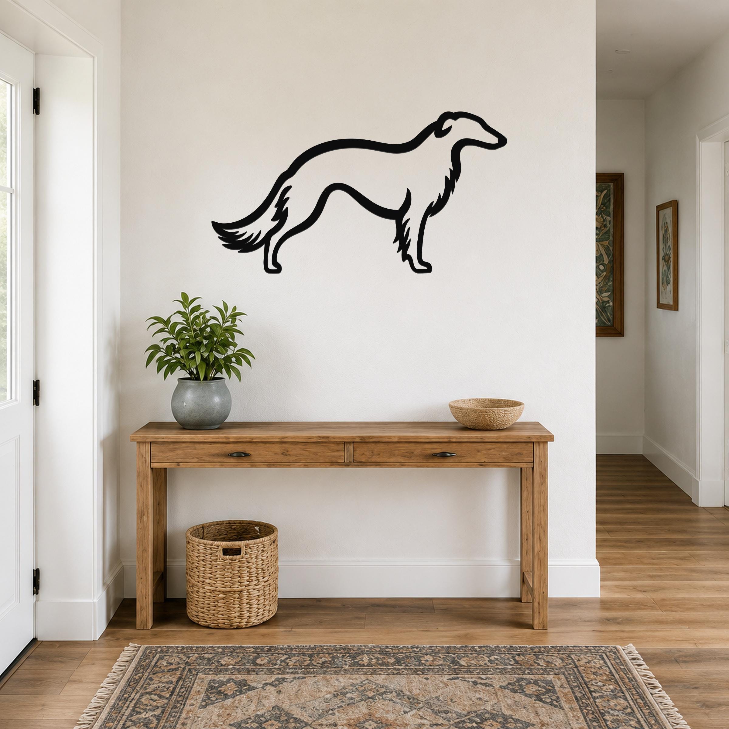 Black metal Borzoi dog wall art silhouette mounted above a wooden console table in a bright entryway.
