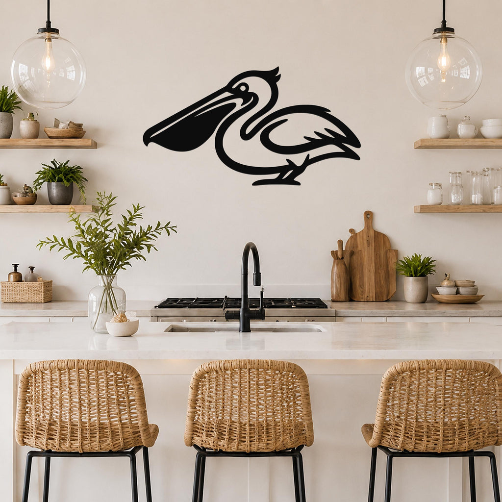 Black metal pelican wall art silhouette mounted above a kitchen counter, featuring a stylized bird with a long beak and curved neck, displayed in a modern kitchen with open shelves and pendant lights.