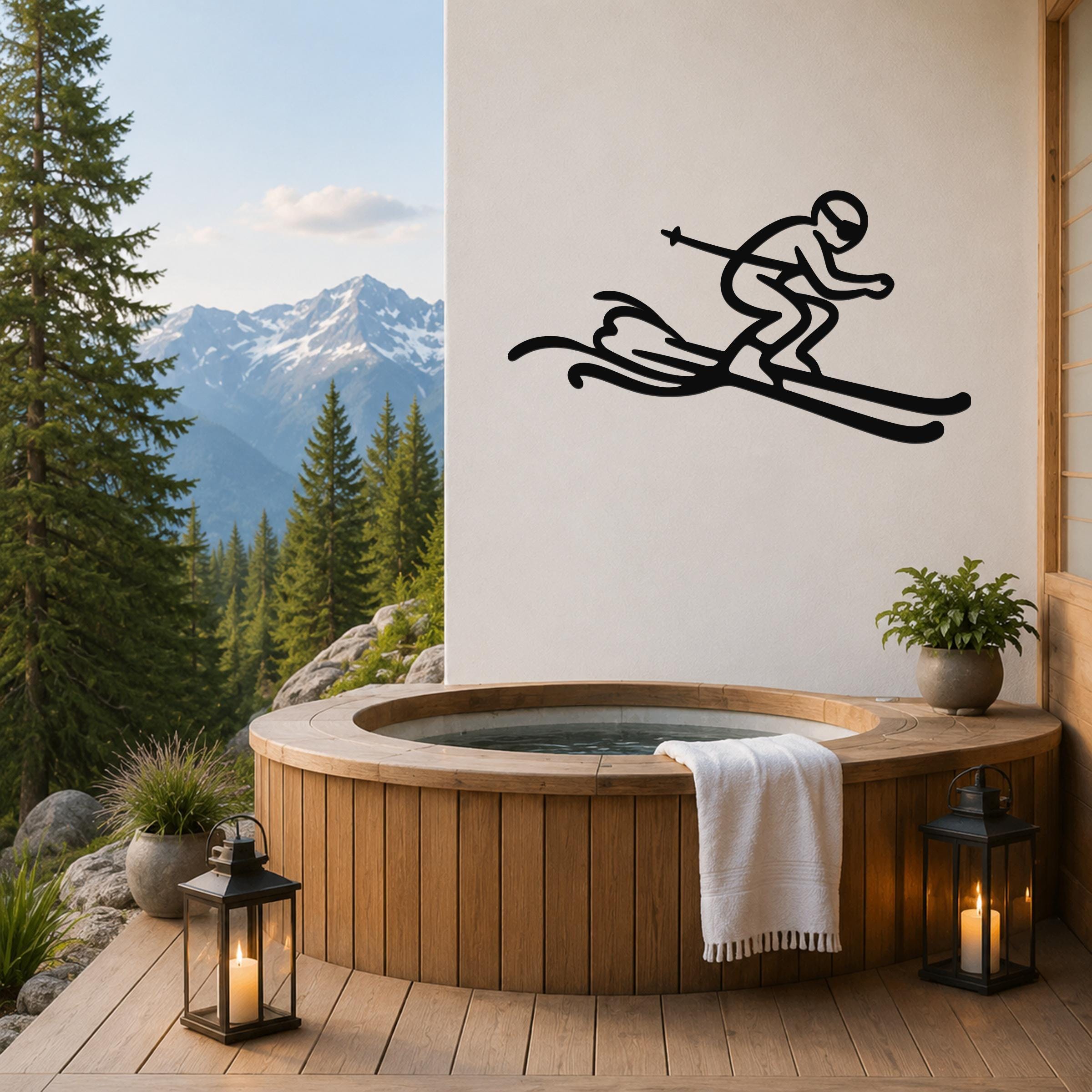 Black metal skier silhouette wall art with motion lines, mounted on a white wall above a wooden hot tub on a mountain-view deck.